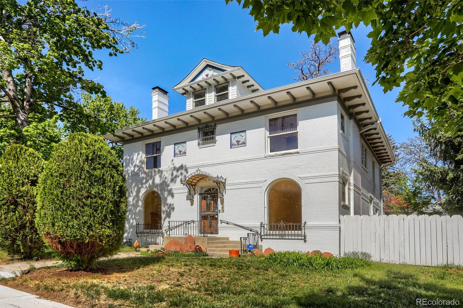 Attention investors and DIYers!  So many intriguing possibilities for this grand three-story 1899 home plus carriage house plus garage/carport on a 12,500 square foot lot on 7th Avenue that is zoned U-SU-B1! This beauty will capture the hearts of those looking for unique vintage architectural features, including FOUR gorgeous fireplaces with carved wood surrounds, transom windows in the upstairs bedrooms, extra-tall ceilings, leaded glass windows, cherubs carved into the bedroom moulding, and a towering wall of windows above the grand center staircase overlooking the expansive estate.  Three stories above ground plus a partially finished basement and a a carriage house with loft.  Interior and exterior entrances to the basement that is already set up for a kitchen and bath plus living and sleeping areas allow for multi-generational living, a nanny suite, or even rental income.  This home is in need of updating and is being sold in “as is” condition, but has a newer roof, newer paint to highlight the exterior architectural features, 2 furnaces and central air, and new hardwood floors on much of the main level.  Update the kitchen and baths, and enjoy the prestige of this home and location in the 7th Avenue Historic District, or enhance the value even more with a complete renovation of the main house and carriage house to highlight all of their stunning attributes. Surrounded by elegant properties along 7th Avenue and within easy walking distance of downtown and Governor’s Park, this wonderful historic home is ready for its next chapter.