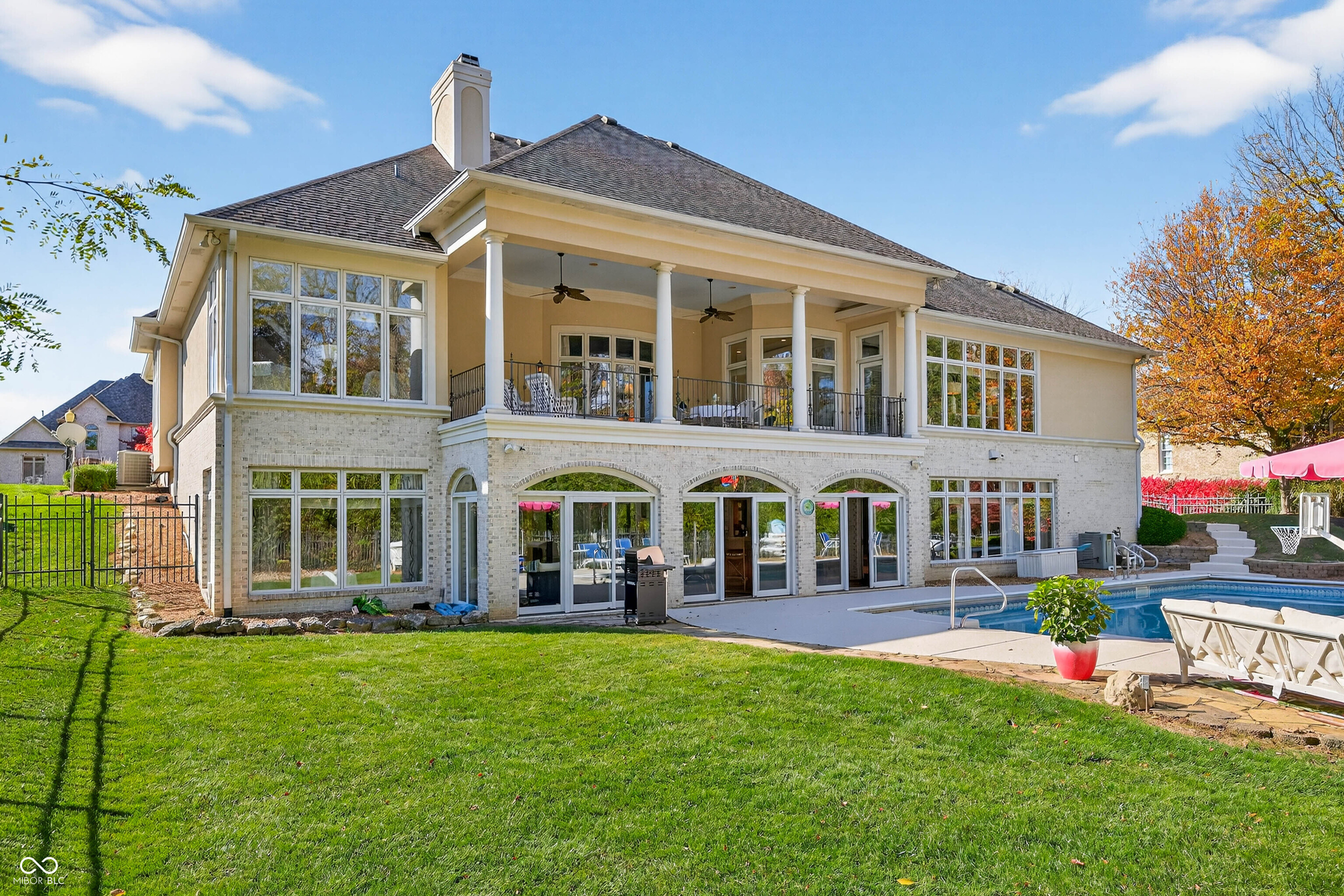 Experience refined luxury and timeless design in this award-winning custom estate by renowned builder Greg Allen-recipient of the 1998 Home-A-Rama "People's Choice" Award. Perfectly positioned in the heart of Center Grove, this residence blends masterful craftsmanship with sophisticated modern updates to create an unparalleled living experience.  Step inside to soaring 14' ceilings, rich architectural detail, and expansive living spaces designed for both grand entertaining and everyday elegance. The newly remodeled kitchen serves as the home's showpiece-featuring premium finishes, generous prep space, and a seamless flow into the main living areas.  With 4 spacious bedrooms, each offering walk-in closets, and 4 full baths plus 2 half baths, the home provides exceptional comfort and privacy for family and guests.  The fully finished 3,450 sq. ft. walkout basement is its own retreat-complete with a full theater room, private exercise room, and a stylish wet bar. Whether hosting game nights, movie marathons, or weekend gatherings, this space delivers endless opportunity.  Outside, your personal resort awaits. Nestled on nearly half an acre, the backyard features a sparkling in-ground pool, multiple outdoor living areas, and lush privacy-creating the ultimate setting for summer entertaining and peaceful relaxation.  A rare combination of elegance, quality, and livability, this Center Grove luxury home offers the lifestyle you've been dreaming of-crafted with intention, updated with care, and designed to impress at every turn.