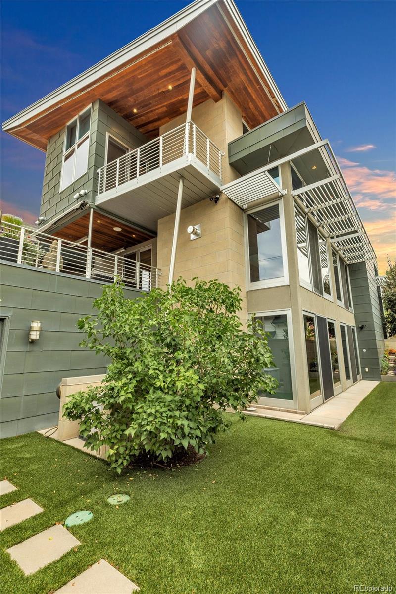 This modern Cherry Creek masterpiece is a true work of art. Sleek, sophisticated and contemporary styling pairs with extraordinary design and exceptional craftsmanship. Including a very rare walk-out level, this home showcases a dramatic entrance, soaring 20-foot ceilings that flows to the great room with a three-story sunny south facing curtain wall. This open-concept layout seamlessly connects the great room anchored by a striking fireplace, honed slate flooring and exquisite finishes. At the heart of the home is a state-of-the-art Bulthaup kitchen, featuring a spacious center island, custom cabinetry, adjoining pantry, kitchen planning desk and room for casual dining. The west facing terrace, has heaters, automatic sunshade, built-in grill and ample space for outdoor dining and seating. Additionally on the main level are two guest bedrooms with en-suite baths, guest powder room and stylish home office with cozy fireplace and museum style glass display shelving. A modern style glass elevator offers access to all three levels. The upper-level luxurious primary retreat includes a sitting area, private covered balcony with mountain views and glass fire tube fireplace. The spa-inspired 7-piece bath with enclosed toilet & bidet, infra-red sauna, jetted tub, steam shower, sink island, custom walk-in closet, and dedicated laundry. The walk-out lower level offers flexible living with glass wall sun-filled recreation rooms with side yard access, gym/4th bedroom with lock off closet & glass wall and a game room/5th bedroom with armoire storage. There is a three-quarter bath, second laundry room, ample storage & utility room. The two-car garage also accesses this level.  Nice extras include a backup Generac Generator & exterior snow melt system. Located just blocks from the vibrant heart of Cherry Creek, this one-of-a-kind property is an iconic expression of modern Denver luxury—designed for comfort, style, and spectacular living.