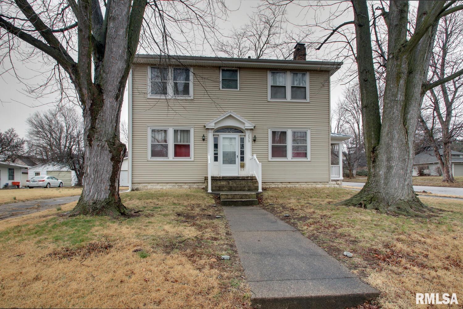Charming 2-story 3 bed 2 bath home with great character and functional space! The main level features a bright living room with fireplace, spacious dining area, and an updated kitchen with breakfast bar, stainless appliances, and plenty of cabinet space. A convenient mudroom off the back leads to the patio and fenced-in backyard—perfect for everyday living. Upstairs offers comfortable bedrooms and full bath. The lower level provides laundry, storage, and additional usable space. Enjoy the inviting covered porch and corner lot setting with mature trees. A warm, move-in ready home close to parks, schools, and amenities!