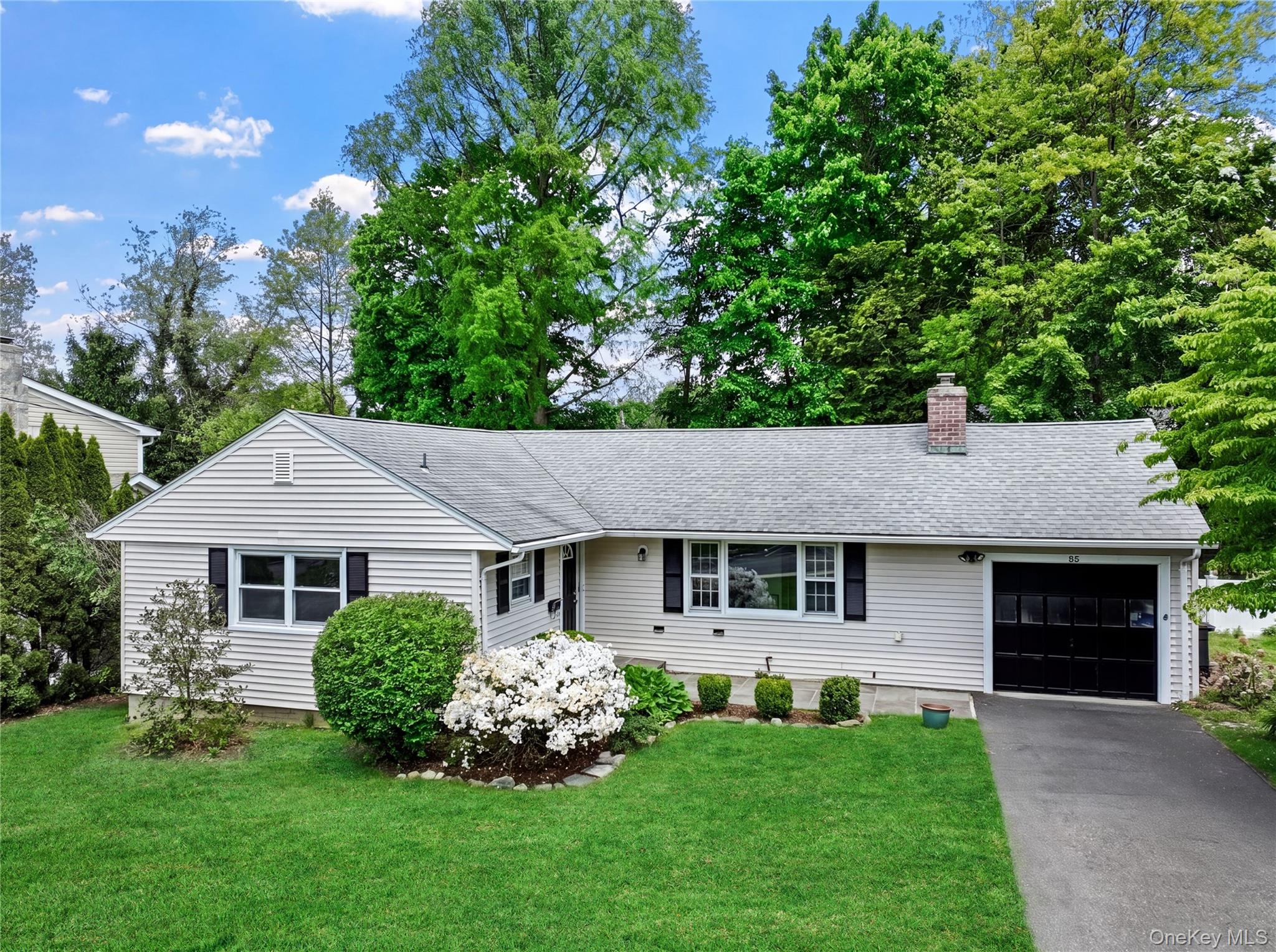 Welcome to your next chapter in the heart of Ardsley — a charming three-bedroom, two-bath home that perfectly blends comfort, convenience, and classic Westchester living. This delightful residence sits just a leisurely stroll from Concord Road Elementary School, local parks, and the vibrant village center. Step inside to discover sun-drenched living spaces graced with gorgeous hardwood floors throughout. The inviting living room features a wood-burning fireplace — and flows seamlessly into the formal dining room, The updated kitchen boasts stainless steel appliances and offers direct access to the patio and beautifully leveled backyard. Down the hall you will find two sizable bedrooms that share a well-appointed hall bathroom, while the primary bedroom enjoys the luxury of its own private bathroom. The lower level provides future expansion of up to 800sqft more living space, generous storage along with laundry and utilities. Conveniently located near school, shops, parks and Metro North Train Station offering easy commuter access, this location truly delivers the best of suburban living with urban convenience. Schedule your private showing today!