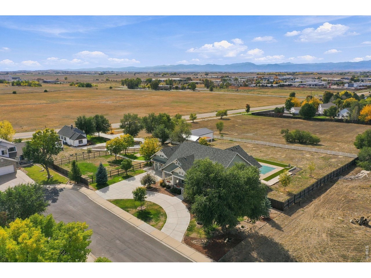 Exceptional Custom Craftsman Estate on Acreage with Panoramic Mountain Views! Welcome to your private sanctuary! This custom Craftsman estate blends timeless architectural elegance with modern luxury, set against sweeping, unobstructed mountain views.Step inside to experience exceptional craftsmanship highlighted by radiant floor heat, crown molding, plantation shutters, and custom window treatments throughout the main living areas. The heart of the home features a gourmet chef's kitchen equipped with a large center island, granite countertops, 42" cabinetry with crown molding, a hooded gas range, subway tile backsplash, and a built-in microwave-all seamlessly flowing into the adjacent dining room.Rest and relaxation await in the generous bedrooms, each featuring a walk-in closet, with the primary suite boasting two walk-in closets and a luxurious 5-piece bath. Designed with total convenience in mind, the home also features a dedicated home gym with its own 1/2 bath and a convenient separate entrance directly off the back patio, as well as an integrated doggie door for pets.Outdoor living is truly unmatched. Enjoy your morning coffee on the classic covered front porch, or entertain on the expansive covered back patio. The extended outdoor living area showcases elegant travertine tile, a pergola, and a built-in grilling station. Take a dip in your private swimming pool while soaking in the stunning mountain backdrop.As a unique bonus, the property includes a charming 1940s farmhouse complete with two rooms (ideal for a home office, studio, or extra storage) and a 3/4 bath. Additional features include a separate storage shed and a massive 4-6 car garage with extra space reserved for pool equipment and workshop needs.
