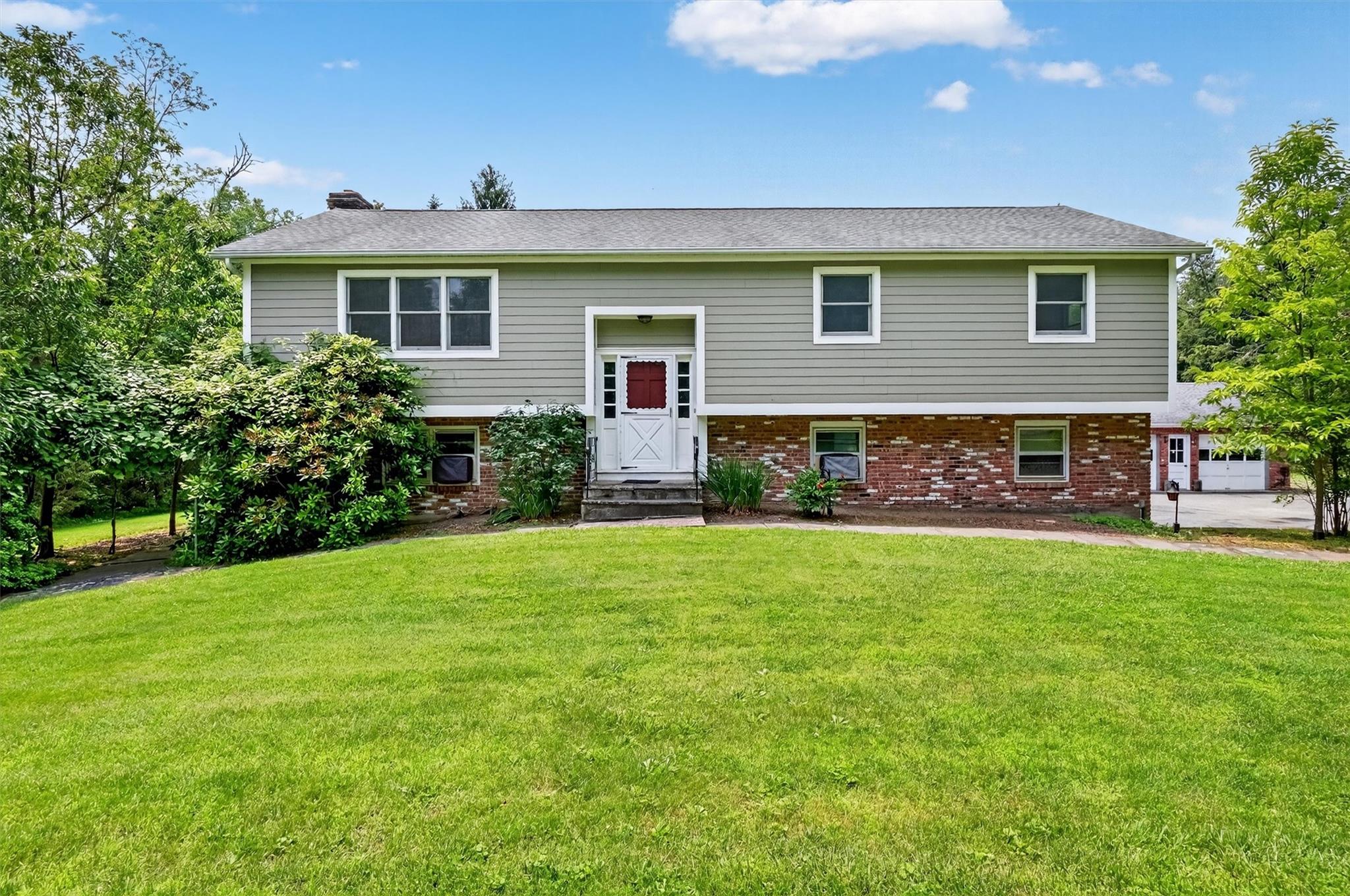 Welcome to this spacious and versatile 3-bedroom, 3.5-bath home, perfectly set on just under 3 acres of beautiful, flat, and usable land. Featuring a durable Hardiplank and brick exterior, this property combines quality construction with endless potential. Inside, you'll find two generous living rooms, a dedicated den/office, and a convenient kitchenette — ideal for extended family or guests. The detached oversized 2-car garage offers ample storage and workspace. With thoughtful updates already in place, bring your vision and finishing touches to transform this home into a true showplace. A rare opportunity to create your dream retreat with room to live, work, and play. This home easily lives like a five bedroom home. A beautiful backyard oasis. This home is located in the town of Somers, in Somers school district, and Yorktown Heights Post Office. A must see.