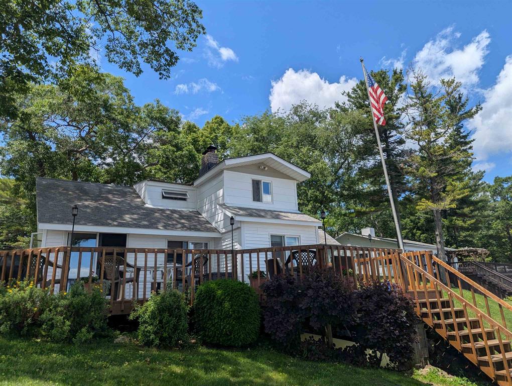 Sandy beach, breathtaking lake views, and so much more are included with this darling cottage that is full of character and along the gorgeous shores of Lake Huron on Crescent Ave by Historic Point Lookout! Sitting on 70' of sandy beach, this property offers fantastic entertaining space and outside enjoyment. The cottage itself features a sprawling layout that provides views of the water throughout. The main level has a huge living room w/ a wood fireplace and a door leading out the awesome front deck w/ a front row view to the beach and water. Also on the main level are the kitchen/dining area w/ a turret style design, mud room w/ dryer, & two bedrooms with the main bedroom having a full bathroom. Upstairs offers three additional bedrooms w/ plenty of sleeping space! Other features include an updated septic system in 2017, city water, natural gas, and a storage shed. A great opportunity to get on Lake Huron and located nearby multiple golf courses, marinas, and in between Au Gres and the Tawases!