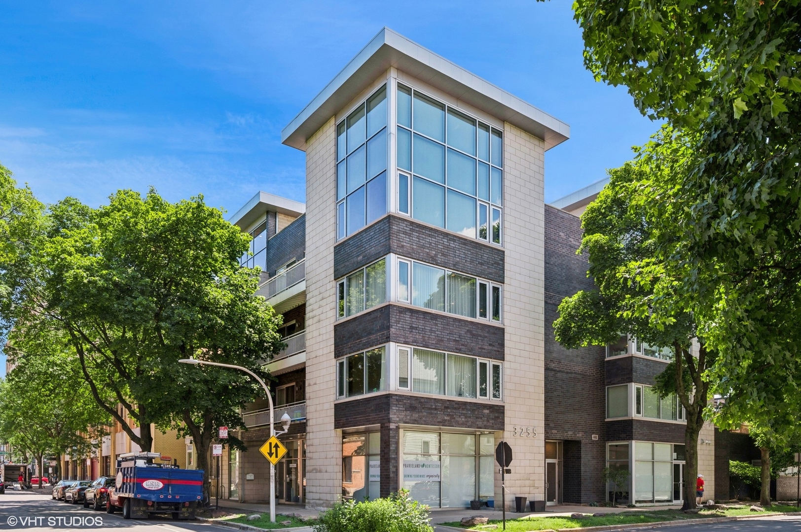 Bright and Ultra-Wide Corner 2 Bedroom, 2 Bath Condo in Boutique Elevator Building in Perfect Lakeview! Overlooking quiet tree-lined streets, sunlight pours through walls of windows all day long. Hardwood floors throughout and soaring 91/2 ft ceilings. The open concept living space features built in surround sound and a cozy gas fireplace-the perfect backdrop for both relaxing and working from home. Private balcony right off the living space is ideal for entertaining or grilling. The sleek kitchen impresses with flat panel cabinetry with tons of storage, under cabinet lighting, tile backsplash, quartz countertops, high-end appliances including built-in Sub-Zero fridge, new undermounted drawer microwave (2025), new dishwasher (2022), and a high breakfast bar with overhang can seat at least four. The primary suite offers room for a king bed, nightstands, and dresser, and professionally organized walk-in closet. Spa inspired bath with double vanity, glass rain and body spray shower, and jetted tub. A spacious second bedroom and updated second bath (new tile in 2023) provide flexibility and style. Enjoy the conveniences of in unit laundry, additional storage closet, and one heated garage parking space included in the price. The well run professionally managed building also boasts a common rooftop deck with skyline views. The best Lakeview location right near Whole Foods, Target, X Sport Fitness, Southport Corridor, Roscoe Village, parks, transit, the Paulina 'L', bus lines, and 90/94 access-and within the Burley School district. This won't last long!