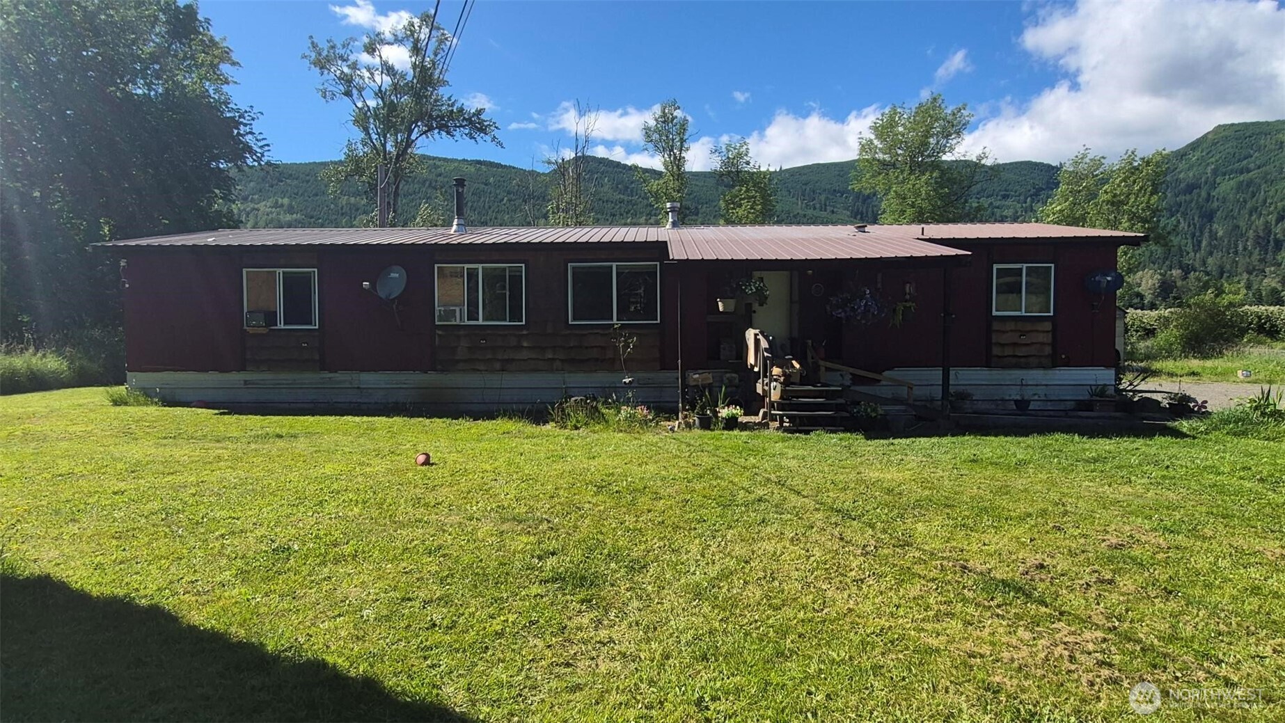 This large 3 bedroom 2 bath manufactured home in the country is very cozy and livable but could benefit from some updates.  With a little work this could be a great rental, flip or your forever home. Situated on 1.5 acres with a large, covered back porch and open-air patio providing a beautiful mountain view. Updated vinyl windows throughout and a metal roof mean some large expenses are already taken care of.  Room for great gardens or even goats! Here is your opportunity for some sweat equity. Please call your agent or listing agent for more info.