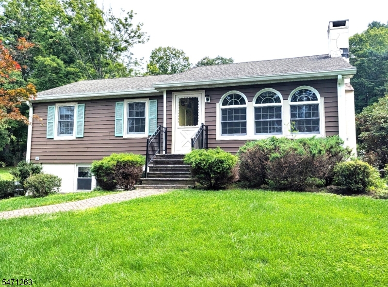 This charming ranch-style home is set on just over a half-acre of private property. The spacious, sun-filled living room features a beautiful stone, wood-burning fireplace, creating a warm and inviting atmosphere. The large, open kitchen offers plenty of space for cooking and entertaining, along with a convenient pantry. Enjoy added peace of mind with a whole-house Generac generator powered by propane, providing reliable backup power when needed. The lower level offers ample storage, laundry facilities, and convenient access to the attached two-car garage.Close to parks, restaurants, shops and highways. Fireplace and chimney and are being conveyed "as is .