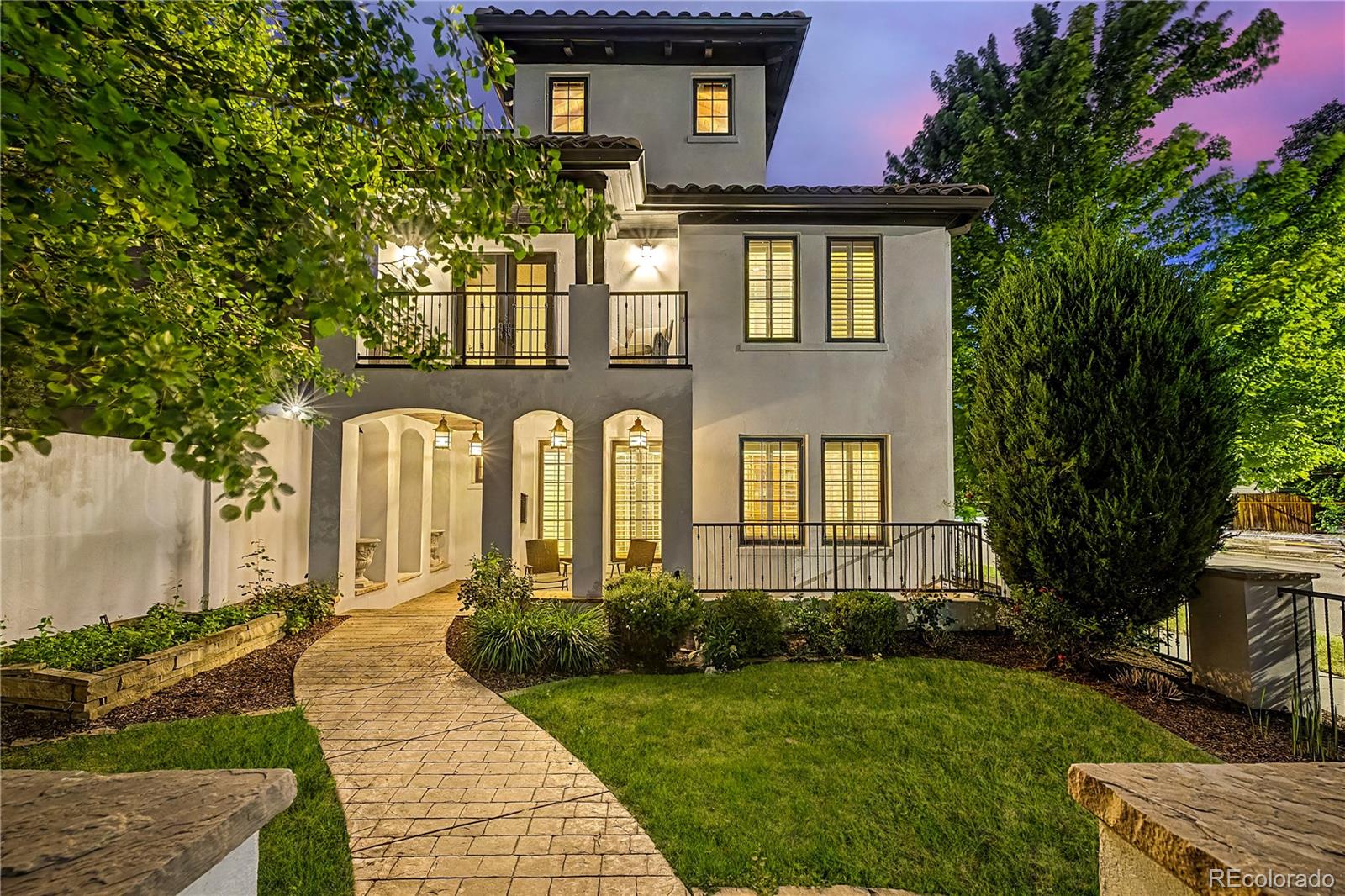 Set on a corner lot in Cherry Creek, this Spanish style home spans 5,759 square feet across four levels. The floor plan balances large gathering spaces with private living areas, and features like a rooftop terrace, multiple balconies, and gated outdoor spaces extend the entertaining well beyond the interior.Marble counters and professional grade appliances define the kitchen, with ample storage throughout. Exposed wood beams and multiple fireplaces add character to the interior, and Sonos speakers paired with a centralized smart home system keep lighting, music, and televisions running through an in home iPad.Rather than concentrated in one place, outdoor spaces unfold across multiple levels. Balconies extend from multiple floors, the rooftop terrace takes in mountain views, city views, and Colorado sunsets, and a fenced yard with a gas fire pit offers another setting at ground level.The home has four bedrooms and seven bathrooms. The primary suite includes a fireplace, private balcony, walk in closet, steam shower, soaking tub, and five piece bath. Three upper level bedrooms each have en suite bathrooms, keeping bedroom areas separate from the main living spaces.On the lower level, a mother in law suite, home theater, and wine cellar add to an already flexible floor plan. Between the indoor rooms and outdoor settings, the home gives everyone somewhere to land across all four levels.The two car garage has EV charging, epoxy flooring, and hot and cold water access. Cherry Creek's restaurants, coffee shops, boutiques, galleries, and shopping are just blocks away.