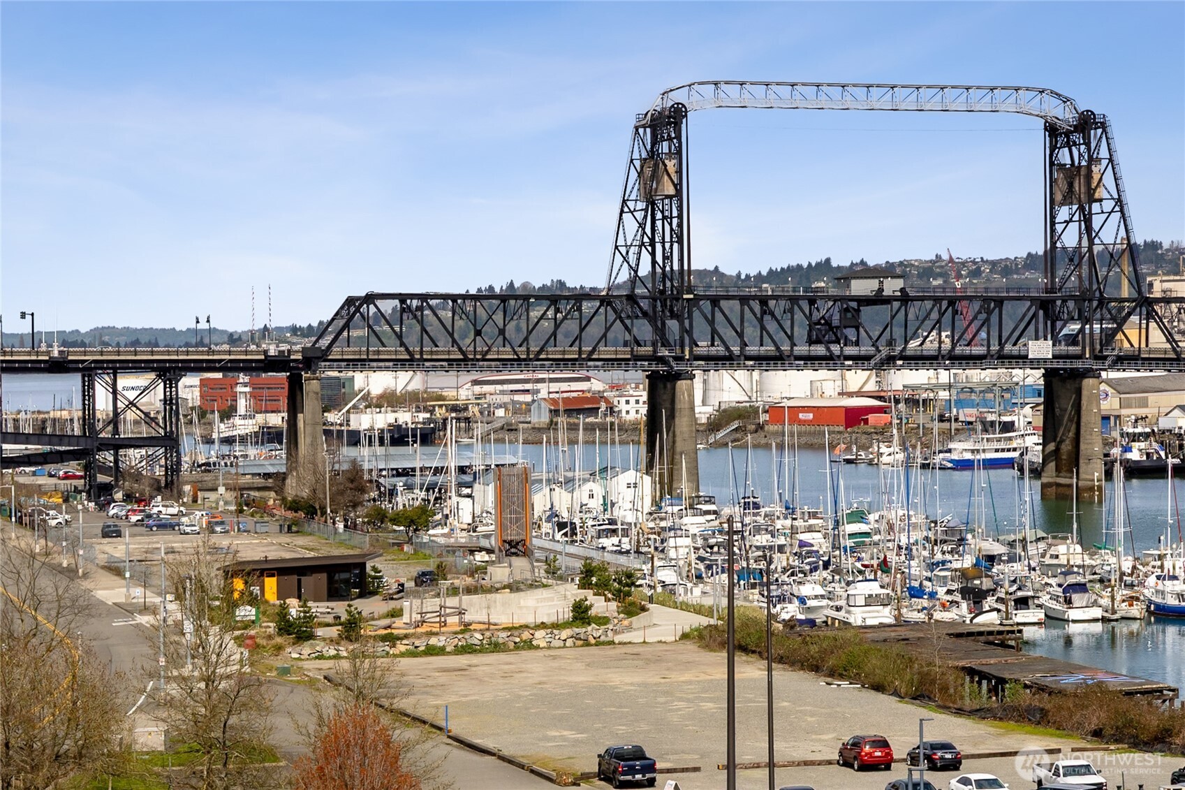 Live in enviable urban style at The Esplanade, downtown Tacoma's most coveted residential address. Condo suite #704 has the very best floor plan in the building: a home office space that easily doubles as a guest room, a laundry room beyond compare, walls of windows along two sides of the home, and a pantry with shelf-genie drawers. In the expansive living room your eyes are drawn to the spectacular city views, looking toward the 11th Street Bridge and Commencement Bay. The vista is even more dazzling after dark! Two covered decks extend your living area all year long. Ideal chef's kitchen invites interacting with guests while you prepare the feast. Your dining room easily accommodates a table with seating for eight plus. Both bathrooms have been fully updated with porcelain stone floors, subway tiles, quartz counters, lighted mirrors and new toilets. Another huge plus - you have three parking spaces, wired for EV connection. Make this your new home just in time to enjoy amazing warm days ahead along the Esplanade walkways. Super location minutes from your favorite restaurants, world-class museums, boutique shopping and endless recreation. Seller to pay 12 months' HOA dues with full price offer.