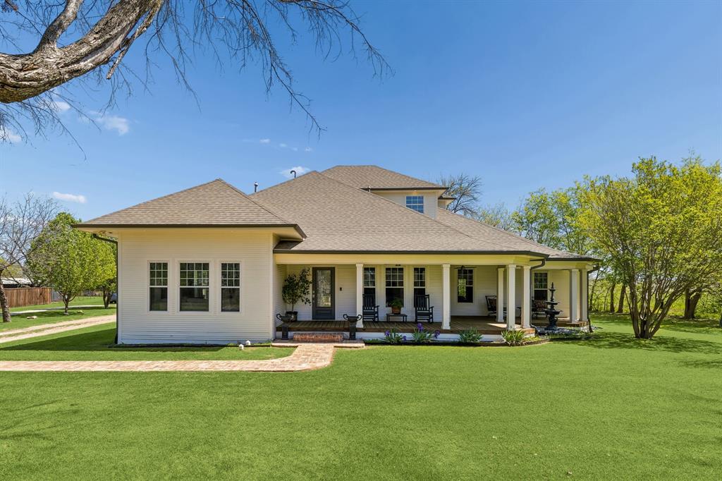 Step back in time and into modern luxury with this stunning 1915 historic home, beautifully remodeled in 2021. Nestled on 1.5 acres in charming downtown Roanoke, this one-of-a-kind property blends timeless character with thoughtful updates throughout and is only two blocks off of Oak Street. A welcoming large front porch invites you inside to an open floor plan. The formal living room features a gorgeous fireplace and built-in bookshelves, while the elegant dining room showcases a stunning chandelier, ample space for large gatherings, and original built-in glass-front cabinets. The chef-inspired kitchen is a true standout, complete with a large island offering seating, cozy built-in banquette seating, two dishwashers, two disposals, two electric ovens, the gas range has double gas ovens and a spacious built-in refrigerator. Just off the kitchen, is the laundry room with a large pantry with plenty of storage. A convenient office with built-in cabinets and desk flows into the spacious primary bedroom, which includes a relaxing seating area. The primary bath pampers with dual vanities, a deep soaking tub, and a separate shower with dual shower heads. Additional highlights include a guest room with built-in bunk beds and reading nooks, plus an upstairs retreat featuring a bedroom with private balcony, a full bathroom, and a large media room perfect for movie nights or entertaining. Outside, enjoy the expansive back deck overlooking a beautiful backyard. There is also a fully equipped 1525 square foot metal building with its own living room, bedroom, bathroom, kitchen, and workshop with electricity. The rustic barn, one of the oldest structures in Roanoke, adds even more character and potential. The backyard also boasts container vegetable gardens and flower beds which are irrigated and controlled by the Rachio app. This rare combination of historic elegance and modern functionality is truly special. Don't miss your chance to call it home!