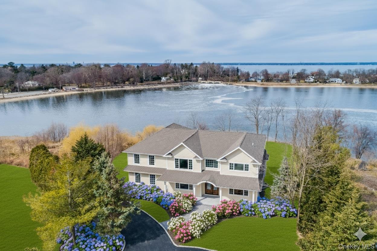 Privately set at the end of a quiet cul-de-sac, this builder-owned colonial, completed in 2020, offers over 7,000 sq. ft. of refined living space with sweeping views of Dosoris Pond and the distant Connecticut shoreline. Designed and occupied by the builder, the home is a showcase of expert craftsmanship, timeless design, and luxurious materials throughout.Inside, you'll find coffered ceilings, custom millwork, and oversized windows that fill the home with natural light and frame water views from nearly every room. The chef’s kitchen flows seamlessly into elegant formal and casual living areas, designed for effortless entertaining and day-to-day living.The primary suite is a true private retreat, featuring a spa-caliber bath, walk-in closets, and a balcony that captures panoramic water views and breathtaking sunsets—a space thoughtfully designed for rest and relaxation.The finished lower level, with 12-foot ceilings and 2,400 sq. ft., offers endless possibilities—ideal for a home movie theater, entertainment center, gym, or creative space.Additional highlights:Built in 2020 with Energy Star Certified construction300 Amp underground electric service4K hardwired motion-activated surveillance systemTwo-zone radiant floor heatingSmart home technologyProfessionally landscaped property with direct pond accessThis is a rare opportunity to own a builder’s personal residence in one of Glen Cove’s most peaceful and picturesque waterfront enclaves—where modern luxury meets natural beauty.
