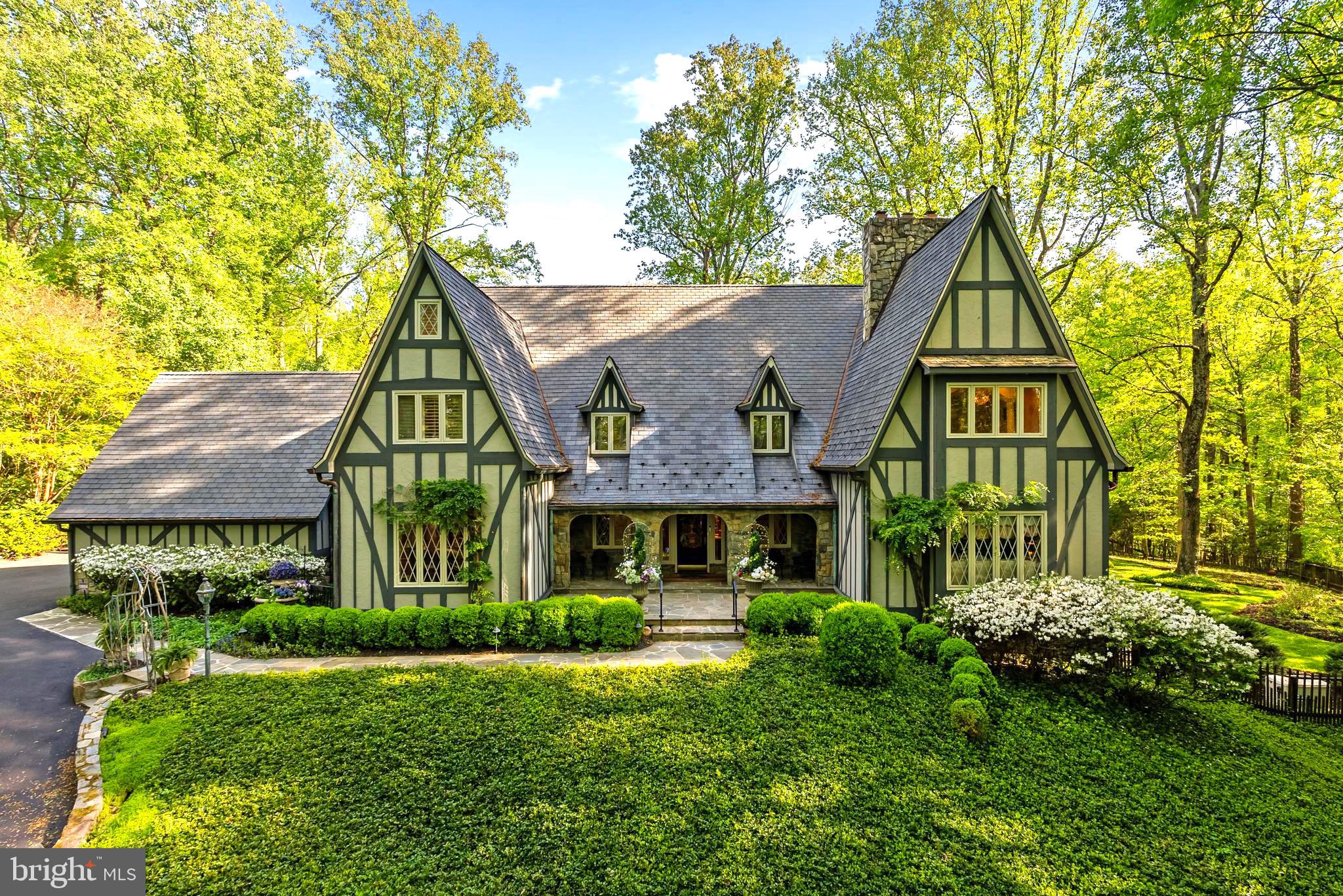 Approximately 7796  Sq. Ft. of  Renewed Living Space, this  HIDDEN OASIS IN ONE OF THE MOST SOUGHT-AFTER AREAS OF VIENNA.  Magnificently sited on 1.23 acres backing to 15 acres of woods, this exceptional estate offers unmatched privacy and character while remaining just minutes from McLean, Tysons, Oakton, and Reston Town Center.The approach begins with a gentle hilltop location and meticulously landscaped grounds framed by mature trees, setting the stage for the romantic architecture and elegant interiors. At the heart of the home, a stunning kitchen by Apex Homes features a custom, expansive design ideal for both everyday living and entertaining. The adjoining formal dining room is highlighted by a dramatic plaster groin-vaulted ceiling and walls of windows that capture serene views of the landscaped grounds and pool beyond. A sun-filled garden room opens directly to the rear terrace, blending indoor and outdoor living. The spacious main-level family room adjoins a paneled study providing the option of a first-floor primary suite.The rear garden is a resort-like destination, featuring stone terraces, formal gardens, fountains, and mature trees—all anchored by a resort-style swimming pool, spa, fire pit, and two custom gazebos.Upstairs, the primary suite offers a fireplace, an extraordinary custom dressing room with handcrafted burled walnut and mahogany cabinetry, and a spa-inspired bath designed for relaxation—two additional bedrooms on this level feature cathedral ceilings and abundant windows overlooking the gardens.  The lower level provides remarkable flexibility for guest accommodations, fitness, media, or lounge space.Every room reflects a commitment to quality and craftsmanship, with timeless design, abundant natural light, and a seamless blend of European character and luxury. This is more than a home—it’s a lifestyle
