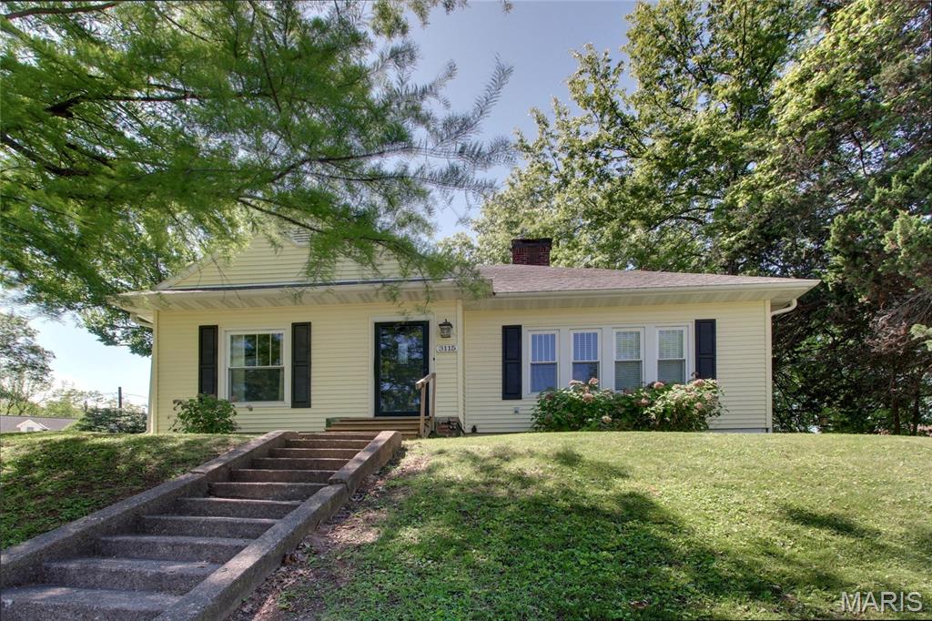 Welcome home to this absolutely darling cottage where vintage charm meets thoughtful modern updates. From the moment you arrive, you’ll be captivated by the inviting curb appeal, lush landscaping, and low-maintenance vinyl siding paired with 6” gutters and gutter guards for true peace of mind. Step inside to discover 1,388 square feet of warm, light-filled living space showcasing gorgeous original hardwood floors throughout the dining and living areas, and bonus: there’s hardwood hiding under the carpet in both bedrooms, just waiting to be revealed! The spacious 14x23 living room is anchored by a stunning fireplace, perfect for cozy evenings and gatherings with loved ones. Replacement windows flood every room with beautiful natural light. The kitchen comes fully equipped with all appliances including stove, refrigerator, dishwasher, and microwave making your move-in seamless. The adjacent dining room features rich hardwood floors that flow naturally throughout the main living spaces and a generous main floor laundry room (washer and dryer included!) adds everyday convenience. You’ll love the beautifully updated bathroom featuring a vintage-look tile design that perfectly complements the home’s classic character. Two comfortable bedrooms offer peaceful retreats at the end of the day. Downstairs, the unfinished poured walk-up basement provides a massive 1,262 square feet of potential, ideal for storage or workshop space. Outside the large lot truly shines with alley access, a detached 1-car garage, and an additional off-street parking slab for 2-3 more vehicles. A rare find! This one wont last, so schedule your showing today!