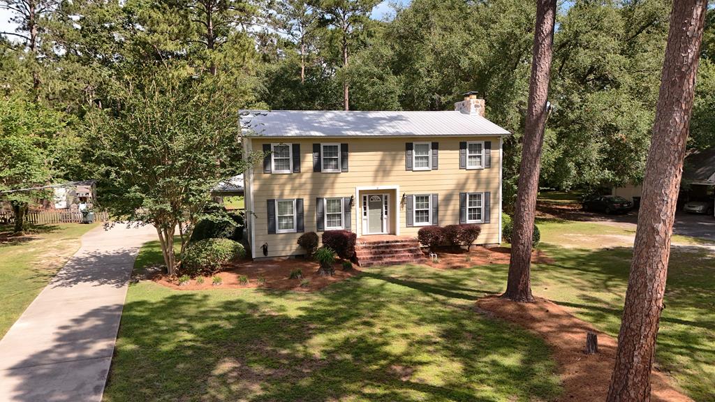 This charming two-story home in the Tall Pines subdivision of Thomasville, Georgia, is nestled on a desirable .74-acre lot within a welcoming community surrounding a prestigious private school. Featuring four spacious bedrooms and three full bathrooms, the home boasts an open-concept living room with large windows, an adjacent dining area perfect for entertaining, and a convenient mudroom. Outdoor highlights include a versatile covered garage area that can double as an outdoor living space and a cozy backyard ideal for landscaping, gardening, or recreation. With a manageable lot size, this property offers ample room for outdoor activities without extensive upkeep. Nearby amenities include parks, shopping centers, and dining options, making it perfect for families seeking both comfort and convenience. For more details or to schedule a viewing, please contact your favorite agent today.