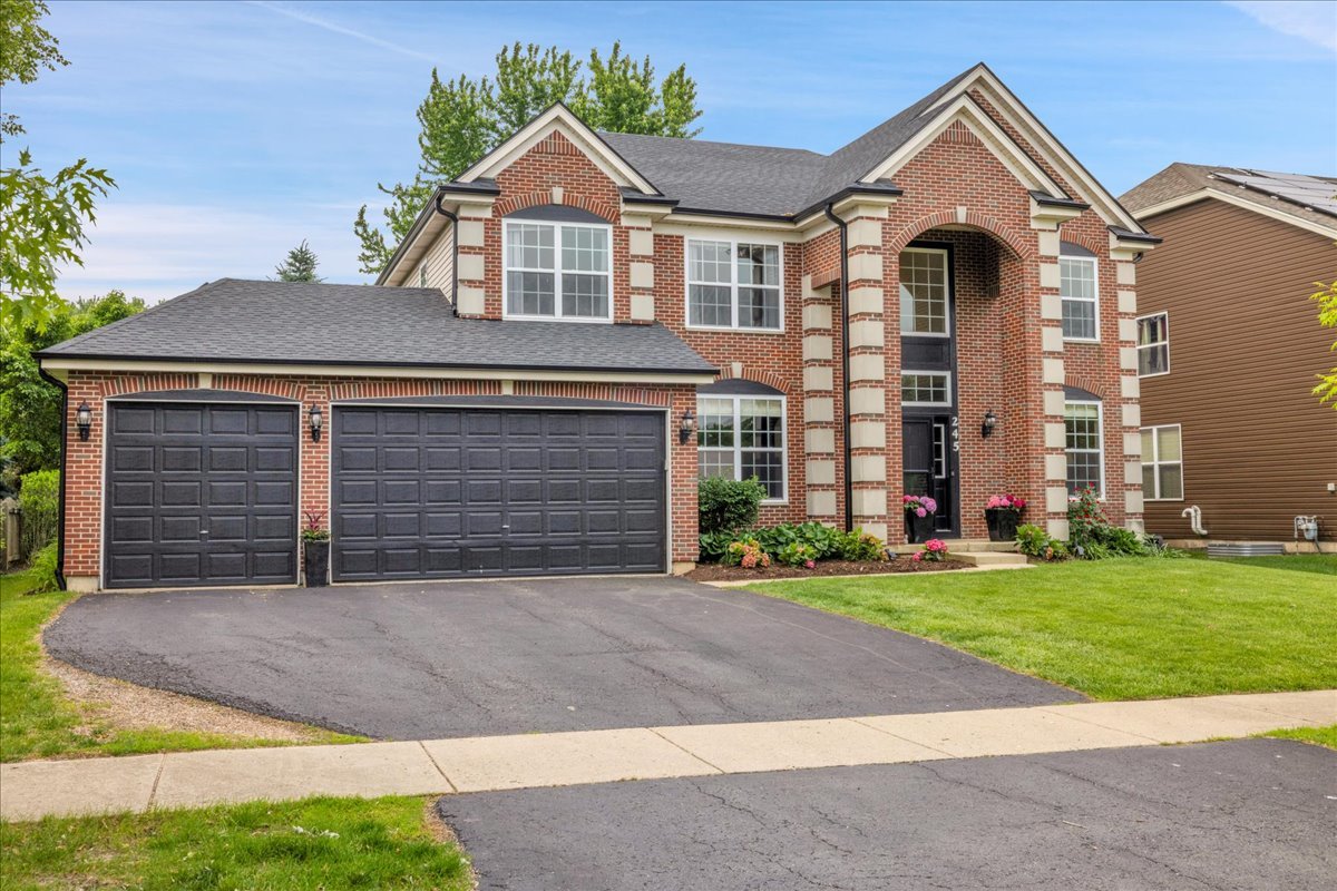Welcome to this impressive 3,254 sq ft brick-front beauty with a 3-car garage packed with charm, space, and stylish updates! With 5 bedrooms and 3.5 bathrooms, this home features gleaming hardwood flooring throughout most of the main level and all of the upstairs, plus gorgeous crown molding and custom window trim that add elegance throughout. The traditional floor plan is both functional and inviting. You'll love the living room with built-in bookcases, the formal dining room ready for holiday dinners, and the family room's stunning custom fireplace with Spanish tile. The heart of the home is the updated kitchen, featuring freshly painted cabinets, a large center island, quartz countertops, stainless steel appliances, and a brand-new Bosch dishwasher. It's the kind of space that makes cooking feel like a treat! In addition to the butler's pantry (perfect wine/coffee station), there is also a massive walk-in pantry! Goodbye to clutter on the countertops! Upstairs, the primary suite is a total showstopper- with two walk-in closets (no sharing required!), including a room-sized dressing closet that opens to a Pinterest-worthy laundry room with pocket doors and a second hallway entrance. The primary bath offers dual sinks, a soaking tub, private water closet, and separate shower. Bedrooms 2 and 3 have their own walk-in closets. The 4th bedroom is oversized and located near the updated hallway bathroom.  Off the garage, the custom mudroom with built-in cubbies (with doors!) helps keep life organized-no more backpacks and shoes in the hallway! The finished basement is where the fun begins-enjoy movie nights in your own home theater with a projector and surround sound, or gather around the rustic, tavern-style wet bar with its stone backsplash, beverage cooler, and plenty of space for snacks and spirits. You'll also find a spacious 5th bedroom, a private office, and a large storage room. Outside is your private escape-mature trees, perennial gardens, a brick paver patio with firepit and built-in seating, and peaceful views of cornfields and woods behind. The app-controlled sprinkler system even has drip lines for your hanging baskets! Just around the corner is a neighborhood park, scenic ponds, and Prairie Point Park-where you can walk to the 4th of July fireworks! Close to top-rated schools, shopping, dining, and everything you need-this home truly has it all. New Roof & Gutters 2023, New A/C 2021, New Furnace 2021, New Water Heater 2025, New Water Softener 2025, SELLER IS A LICENSED REAL ESTATE AGENT