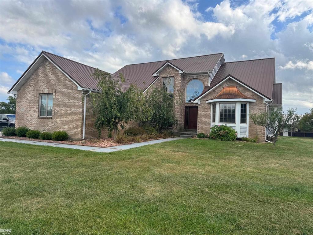 Peaceful country living on just over 20 acres! This spacious home welcomes you with a bright entryway featuring large windows and flows into a stunning two-story great room with a natural fireplace.  The remodeled kitchen (2023) offers cherry cabinets, quartz counters, center island and walk-in-pantry, while the formal dining room showcases elegant marble tile flooring.  The first-floor master suite includes a WIC, and the second-story - open to the main level - features a second master suite! All bathrooms fully renovated. The full, finished basement adds even more living space with a second natural fireplace.  Outdoors, enjoy a patio for entertaining, a 32x48 barn, plus an additional 16x24 outbuilding.  A 3-car attached garage completes this exceptional property.  Newer metal roof (5 yrs). A rare find for those seeking space, privacy, and modern comforts in a serene country setting!