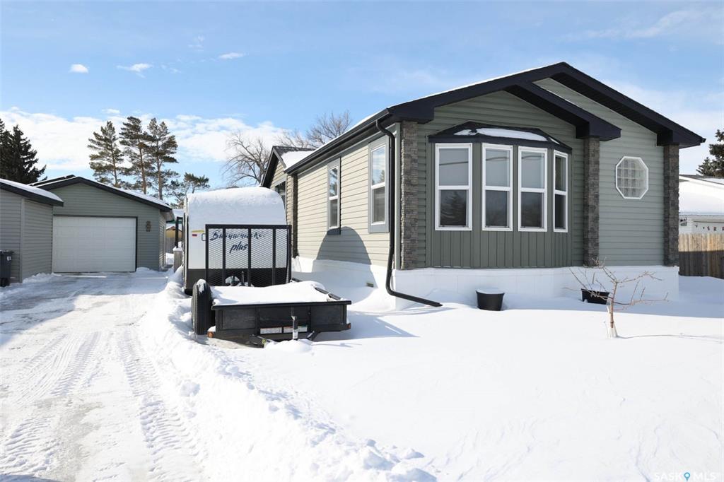 Welcome to 229 Poplar Street in the charming community of Wolseley, Saskatchewan — The Town Around a Lake — where history, natural beauty, and small-town warmth come together.Proudly offered by the original owner, this exceptionally well-maintained 2013 manufactured home delivers an impressive 1,694 sq ft of thoughtfully designed living space. Vaulted ceilings and an open-concept layout create a bright, airy feel throughout the main living areas. The modern kitchen features a large island, abundant cabinetry, and seamless flow into the dining and living rooms — perfect for entertaining or everyday family life.The primary suite is privately positioned at the front of the home and includes a full 4-piece ensuite. Toward the back, you’ll find a spacious family room, two additional generously sized bedrooms, and another full bathroom — an ideal setup for family members or guests seeking added privacy.A second entry leads into a convenient mudroom/laundry area — a practical bonus for busy households.Step outside and enjoy everything this beautiful lot has to offer. The yard includes a fenced area, mature trees, and a separate open green space perfect for extra parking, kids at play, or hosting gatherings. A custom-built firepit area adds charm and creates the perfect setting for relaxing summer evenings.The exterior features maintenance-free siding and a large deck spanning the side of the home — ideal for outdoor entertaining. The impressive 20' x 28' insulated detached garage is heat-ready and equipped with a 220 plug and 30-amp breaker for trailer parking. Two storage sheds provide even more functional space.Additional upgrades include:• Solar panels installed on the garage (2019)• Reverse osmosis water system• New water heater (2024)• Home secured on 18 screw pilesThis one-owner home truly shows pride of ownership and is completely move-in ready.Schedule your private showing today — you won’t want to miss this one!