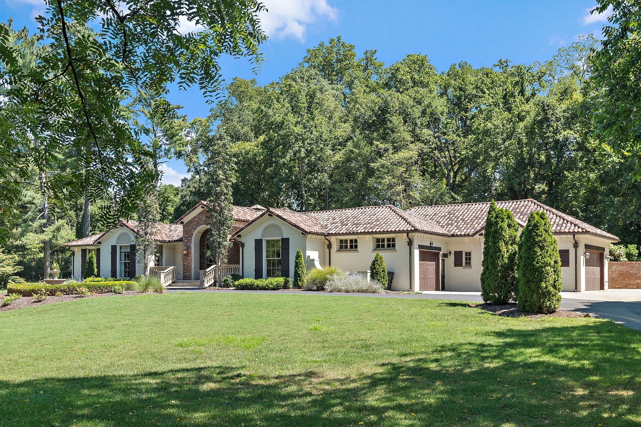 A stunning and impeccably chic Edwin Keeble residence gracefully positioned on 1.2 private acres in prestigious Belle Meade. Designed for effortless one-level living, this architectural showpiece features soaring ceilings with impressive millwork, dramatic floor-to-ceiling custom windows, and a seamless blend of formal and relaxed living spaces. The sleek chef’s kitchen is a true statement with a waterfall island, designer finishes, wet bar, and effortless flow into the dining and outdoor living spaces—ideal for sophisticated entertaining. The oversized den just off the kitchen offers a warm, intimate retreat with custom built-ins. The primary suite is a private sanctuary with separate his-and-hers dressing spaces, an extraordinary custom closet and French doors opening to a secluded patio. Spa like primary bathroom with soaking tub, walk-in steam shower and heated floors. Additional highlights include: 3-car garage, Commercial-grade air filtration system, F5-rated tornado room, Whole-home Kohler generator, NEW custom windows throughout, Encapsulated crawl space, EV charging station, and a circular driveway. Walk to the highly anticipated Belle Meade Village for premier shopping and dining while enjoying the prestige, privacy, and security of Belle Meade living. Furnishings available by separate agreement.