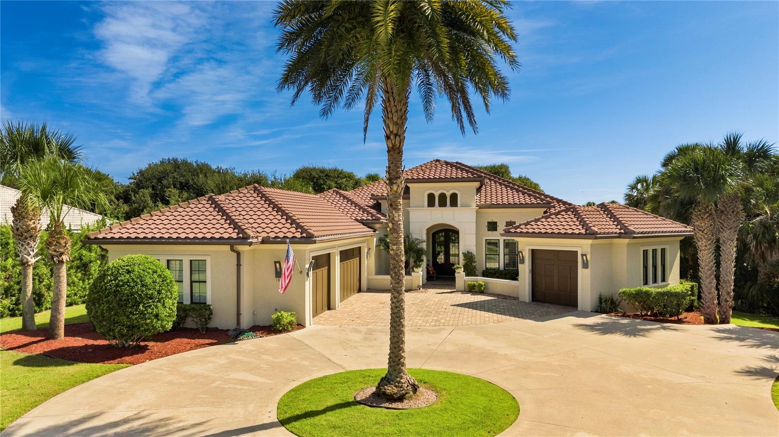 Under contract-accepting backup offers. Welcome to luxury coastal living in Island Estates, an exclusive gated island community in Hammock Dunes bordered by the Fox Cut Canal and the Intracoastal Waterway. Built in 2017, this custom waterfront sanctuary features 3,706 square feet of open-concept living space set on a premium, wide estate lot framed by mature tropical landscaping and magnificent oak trees.The home welcomes you through an elegant foyer with custom stone wall detailing that opens to a soaring, 47-foot-wide great room and formal dining area with warm hardwood flooring throughout. Designed for effortless indoor-outdoor living, massive 10-foot sliding glass pocket doors vanish completely to merge the interior with the outdoor lanai, filling the space with natural light and serene water views. At the heart of the home, the gourmet chef’s kitchen boasts custom white-painted cabinetry, premium stainless steel appliances, wall oven and Advantium microwave oven, a gas cooktop, a beverage refrigerator, pot filler, a spacious center island with breakfast bar, and a large walk-in pantry.The functional split layout offers four bedrooms and four full bathrooms, with each bedroom featuring its own private en-suite bath including one conveniently configured as a pool and cabana bath. The primary suite serves as a serene retreat featuring direct pool access, sweeping views, and a spa-inspired bath complete with dual vanities, a deep soaking tub, and an oversized walk-in shower. A dedicated home office provides a private, productive workspace, while modern conveniences include integrated surround sound audio, complete video surveillance, hurricane impact windows and doors, a whole house generator plus an oversized 4-car garage. The property has been impeccably maintained with recent updates including two new HVAC systems (2025), a new washer and dryer (2025), and new exterior French doors (2026).Outdoor living is centered around direct waterfront views, featuring an expansive covered lanai equipped with an integrated TV setup, a gas-burning fireplace, and a new outdoor grill (2026). Beyond the lanai, relax by the sparkling pool and spa, which features a newly refinished spa surface (2026) and new pool heater (2025/2026). Situated in an X flood zone with elevated FFE for peace of mind, the property boasts approximately 147 feet of direct canal frontage with direct access to the Intracoastal Waterway, offering the perfect canvas to build your own custom private dock.Located in prestigious Hammock Dunes in Palm Coast, residents enjoy serene, quiet beaches and frequent local wildlife sightings right in their backyard, all while remaining just an hour away from Jacksonville and Orlando. An optional membership is available to the award-winning Hammock Dunes Club—a Distinguished Emerald Club of the World and Platinum Club of America—which features two Audubon-certified golf courses, an oceanfront clubhouse with multiple dining venues, a resort-style pool, a 5,000-square-foot fitness center, tennis, pickleball, bocce ball, and three beachside croquet courts.