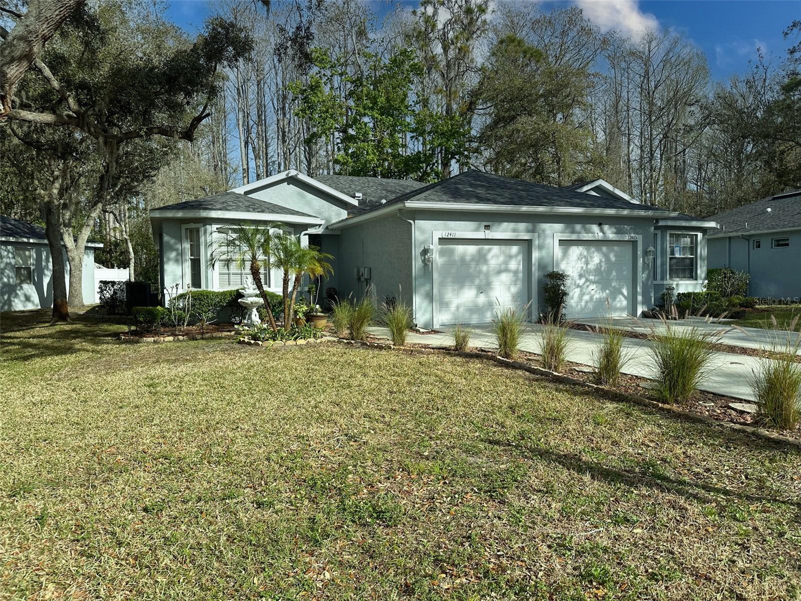 Buyers wanted. Absolutely gorgeous villa. Like a showcase. Just reduced. Move in ready home. Very well maintained. 2 pane class windows. New roof in February 2025, that that gives you a peace of mind for years to come. Investor friendly community. It can be leased immediately. Woods in the back. Tile floor in the wet areas, kitchen/bathrooms. The rest is engineered wood. Monthly HOA fees cover lawn care, exterior painting and power washing, also roof replacement, shrubs, irrigation, repainting of the exterior, trash, pest control. Both bathrooms and kitchen recently updated. Living room has sliding glass door to back patio with outdoor grill and view of a peaceful back yard and woods. Extra long driveway that can fit several cars. Turn key condition. This place will exceed your expectations...! Conveniently located close to all major roads. Medical facilities, restaurants, shopping, car dealerships and Gulf of Mexico, .. and yet it's a NO FLOOD zone...! Only bout 40 minutes to Tampa International Airport. Make an appointment to see it and you will love it. It can be the next place you call home. Enjoy relaxed care free Florida living at it's best.