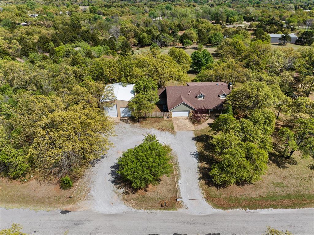 Welcome to 8404 Blackberry Ridge, where function meets flexibility. This property features a 30x40 shop with a 14’ RV door and two 10’ overhead doors—a rare find and perfect for RV storage, a workshop, or serious hobby space.Inside, the home offers a layout built for both everyday living and entertaining. The main level includes two living areas, two dining spaces, a dedicated office, half bath, and laundry room, giving you the flexibility today’s buyers are searching for.Upstairs, you’ll find 3 bedrooms, 2 full bathrooms, and a loft-style flex space—ideal for a third living area, game room, or additional office. The primary suite is a true retreat featuring its own wood-burning fireplace, adding warmth and character you don’t often see.Situated in North Edmond with convenient access to I-35 via Waterloo Rd for shopping, dining, and major routes, this home combines space, versatility, and a hard-to-find shop setup.