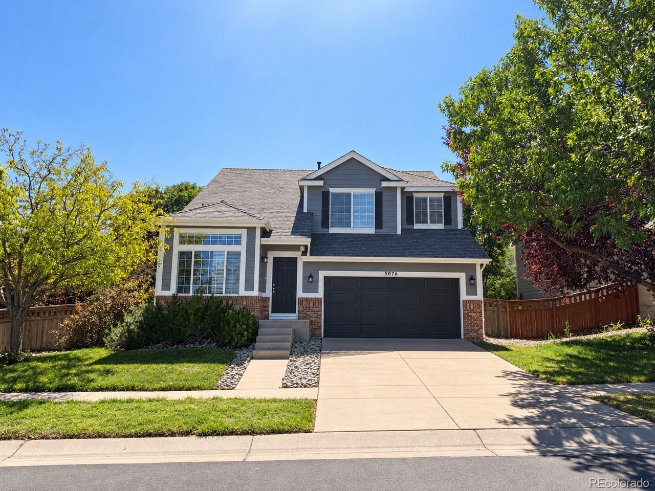 Welcome to this spacious 6-bedroom, 3-bathroom two-story home offering 2,812 finished square feet with plenty of room to spread out. The main level features vaulted living and dining areas filled with natural light, along with an open-concept family room highlighted by a gas fireplace. The eat-in kitchen offers a center island, generous pantry space, and easy access to the backyard. Upstairs, the primary suite features a five-piece bath with an oval soaking tub and walk-in closet, along with three additional bedrooms. The fully finished basement adds two conforming bedrooms and flexible recreation or home office space. Outside, enjoy a spacious, fully fenced backyard with plenty of room for the kids to play. Central air, a spacious main-floor laundry room, and an attached two-car garage complete the home. Conveniently located close to shopping, grocery stores, and a variety of everyday amenities, this home offers plenty of space in a convenient Brighton location.