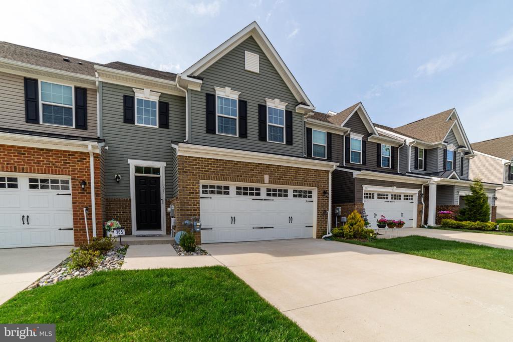 Welcome to 305 Hidden Acres in Foxtail Creek Townhomes, an exclusive 55+ community offering low-maintenance living in a serene, beautifully landscaped setting. This desirable middle-unit townhome is ideally positioned on a premium lot with peaceful views of the surrounding natural landscape.Thoughtfully designed and expanded by an additional 8 feet, this home offers enhanced living space that sets it apart. Inside, you’ll be greeted by stunning luxury vinyl plank flooring that flows seamlessly throughout the main level. The open-concept kitchen is both stylish and functional, featuring granite countertops, crisp light gray cabinetry, and elegant crown molding—perfect for everyday living and effortless entertaining.The adjoining great room boasts vaulted ceilings and an abundance of natural light, creating a bright, open atmosphere. The main-level primary suite is a true retreat, offering generous space, a well-appointed ensuite bath, and ample closet storage.Upstairs, a versatile loft overlooks the great room below, providing the perfect space for a home office, reading nook, or additional lounge area. Two spacious bedrooms, each with walk-in closets, along with a full bath and bonus storage room, complete the second level.The outdoor space offers a unique opportunity to design a custom patio or deck tailored to your vision—an ideal setting to create your own private retreat and take full advantage of the tranquil surroundings.Experience comfort, flexibility, and elevated living at 305 Hidden Acres—where thoughtful design meets opportunity.