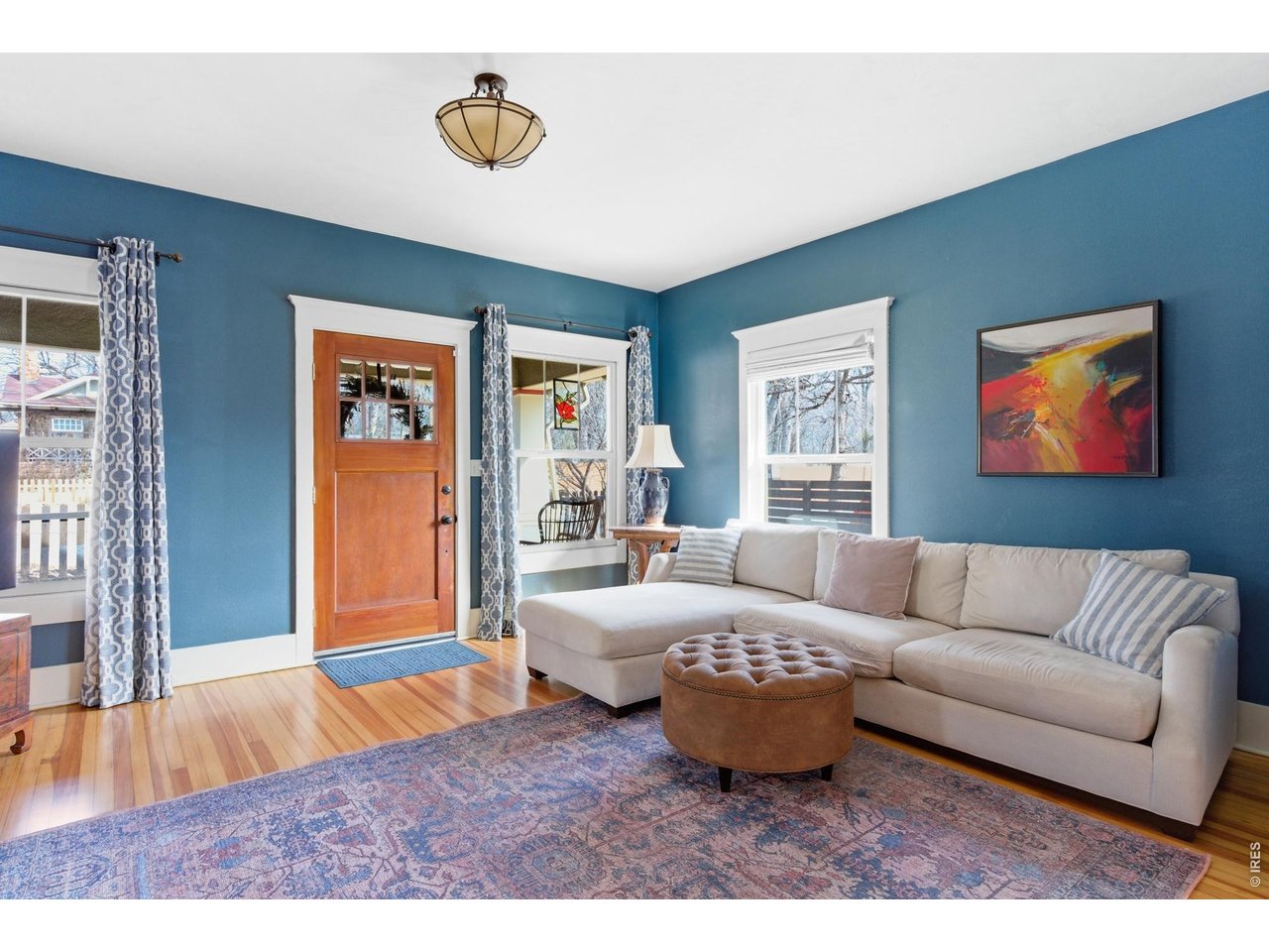 Exuding timeless elegance, this meticulously maintained 1920 Craftsman seamlessly blends historic character with refined modern updates. Offering 2,002 sq ft, this 3-bedroom, 2-bath residence includes a dedicated office and a beautifully finished basement with a full living room ideal for entertaining or everyday living. The thoughtfully updated kitchen showcases custom cabinetry, expansive counter space, and exceptional functionality, creating a true culinary centerpiece. Original pine flooring and a striking wood-burning fireplace preserve the home's rich architectural heritage. The spacious primary suite serves as a private retreat, featuring its own ensuite bath with generous proportions and a stunning clawfoot soaking tub-perfect for spa-like relaxation. Designed for exceptional indoor-outdoor living, the expansive, fully fenced grounds offer two covered patios, one uncovered patio, and a hot tub for year-round enjoyment. A detached one-car garage with opener adds convenience, while a newer hot water heater, and active radon mitigation system provide confidence and peace of mind. A rare opportunity to own a distinguished Craftsman where luxury, character, and comfort converge.