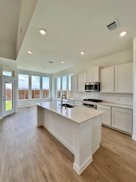 LENNAR - Legacy Hills - Moonstone with Media -This two-story home has a unique layout that is perfect for families who need space. There are two bedrooms on the first floor, including the owner’s suite in the back of the home and a smaller suite off the foyer. The open living space is beside the owner’s suite and has a back patio. Upstairs are two bedrooms and a versatile bonus room loft.Prices, dimensions and features may vary and are subject to change. Photos are for illustrative purposes only.
