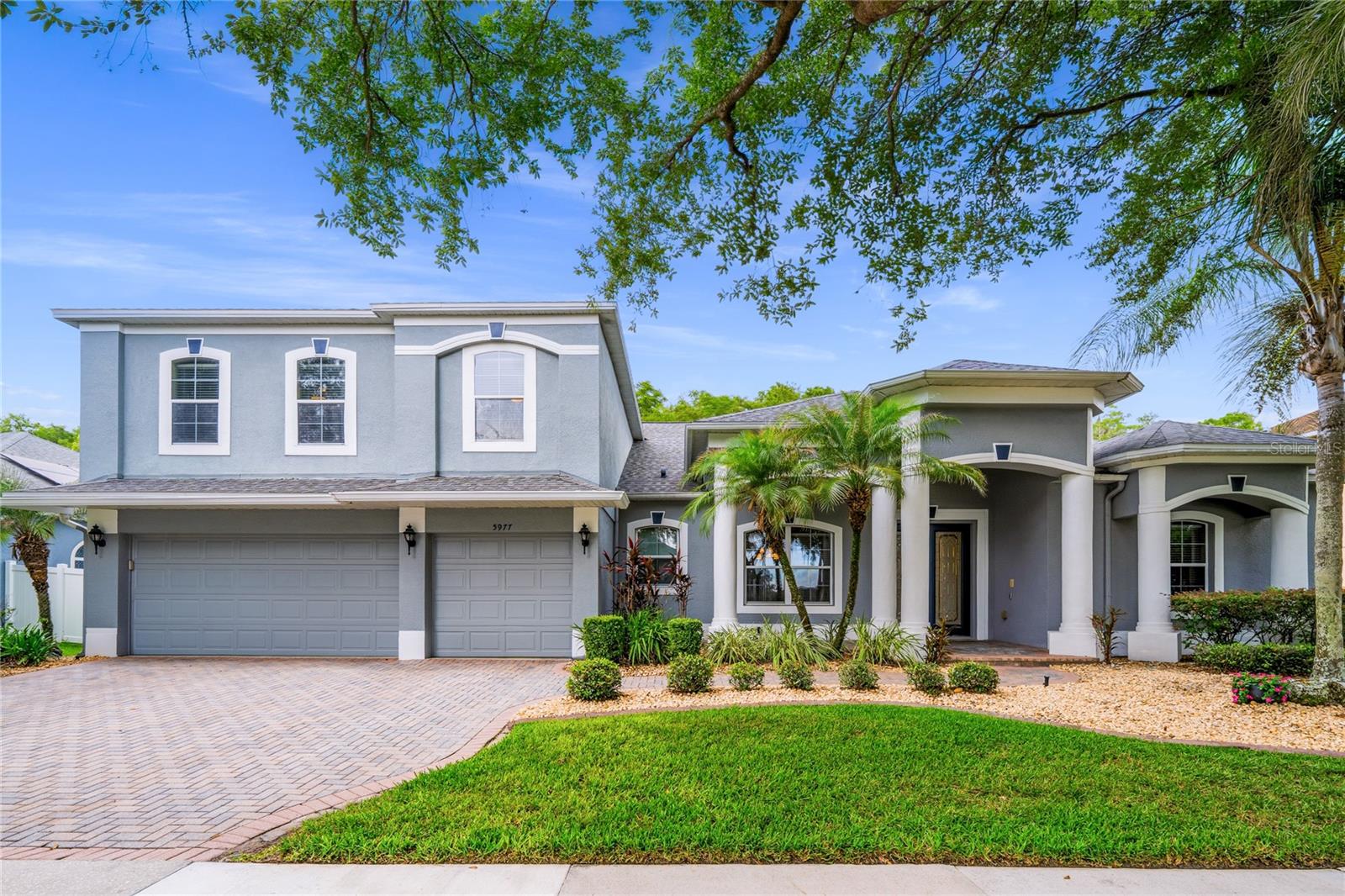 Welcome to the highly desirable Melrose subdivision in Vista Lakes, a private gated community with only 81 large homes. This 5-bedroom 3 1/2 bath is a 3-way split plan pool home nestled on a wooded conservation lot with no rear neighbors! * All living is on the main level except the bonus room * Enter through a gracious covered porch to a tiled foyer overlooking formal living & dining areas with arches, faux stone pillars and hardwood floors * Line-of-sight from the foyer to the covered & screened lanai, pool & conservation area * Primary bedroom and adjoining office are immediately to the right of the foyer (floor plan available) * Spacious (18’ x 12’) primary bedroom with private access to the covered lanai and screened pool * Oversize walk-in closet, Crown molding, arched niche and zoned HVAC! Renovated and luxurious primary bath - impressive step-in shower with 7’+ high seamless glass surround, expansive 11 foot quartz top double vanity with knee space, Merich 5’ jetted soaking tub, private water closet, large walk-in closet with built-in organizers, rods and shelves in addition to a secondary closet for additional storage * Primary bedroom has access to large (14’ x 12) nursery/office with wide plank luxury vinyl flooring and access to the foyer * From the Primary bedroom the tile walkway leads to the renovated kitchen and family room * Renovated and spacious (16 x 13) kitchen is a chef’s delight with cooktop, double oven, rich cherrywood cabinets with staggered upper cabinets, dentil crown molding, massive amounts of exotic granite countertops, 2 sets of double pan drawers, center island and breakfast bar * Kitchen with adjoining breakfast nook has seamless glass bay window for an unobstructed view of the pool with waterfall and the family room with wide plank luxury vinyl flooring, access to the 3rd and 4th bedrooms and renovated guest bath * Completing the 3-way split is a 5th bedroom with remodeled pool planned bath *  Off the kitchen is the laundry room, entrance to the 3 car garage and staircase leading to the bonus room * Light & airy and expansive (28x19) bonus room with half-bath and wide plank luxury vinyl flooring feels even larger due to plenty of natural light and vaulted ceiling * Bonus room has both walk-in and step-in closets for additional storage * Covered and screened lanai overlooks a 30’ x 15’ freeform pool with stacked stone cascading waterfall and peaceful conservation view * Double pane windows and recessed lighting throughout * Oversize (27’ x 24) garage for additional storage * Vista Lakes community with resort style living offers amenities including an Olympic-sized heated pool with waterslide, a kiddie splash area, tennis and pickleball courts, community fitness center and club house you can rent for special events, basketball court, dog park, multiple pools, playground, baseball field with batting cages, soccer field, scenic walking trails, parks and a vibrant community calendar of events * Easy walking distance to the Vista Lakes neighborhood Publix, gas station, doctors’ offices, local restaurants, Urgent Care, pharmacy and more * Within minutes of major highways - 417, 408, 528, Orlando International Airport, and  less than an hour’s drive to the Atlantic beaches * HOA dues are approximately $271/quarter * Currently zoned for Vista Lakes Elementary, Odyssey Middle, Colonial High School * Old Republic Home Warranty