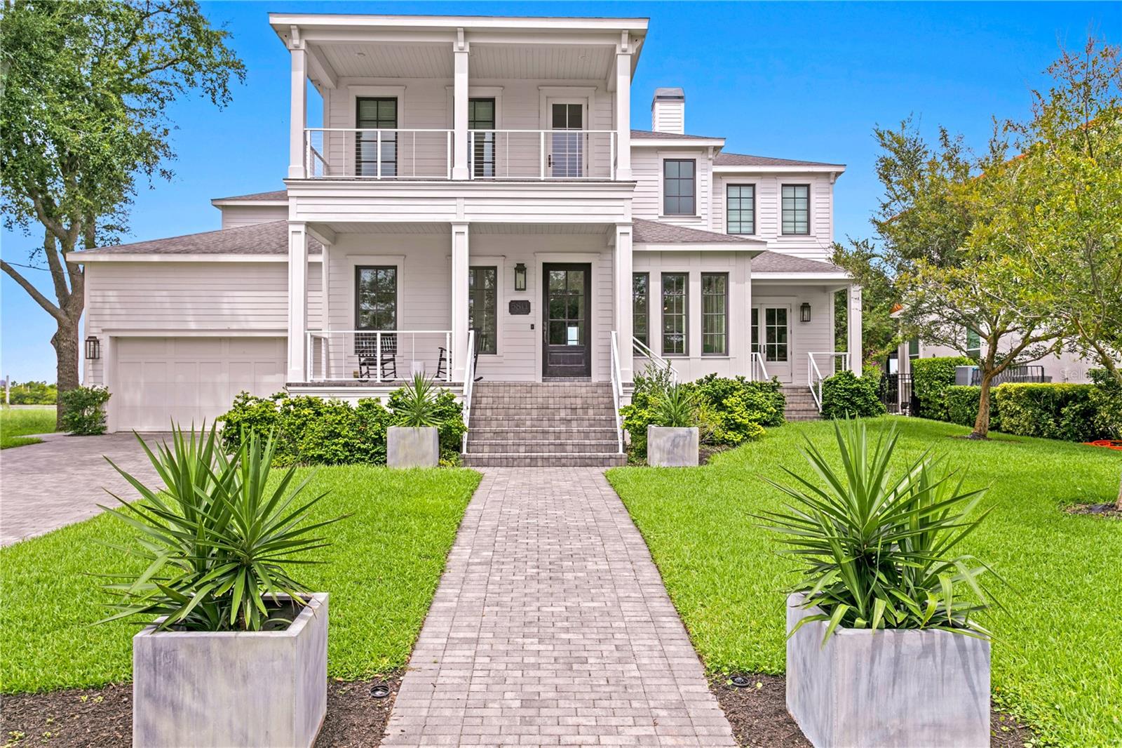 Minutes to the OPEN BAY and nestled among the shore of Tampa's coveted BEACH PARK neighborhood, this extraordinary 5-bedroom, 5 1/2 bath plus office, WATERFRONT home features over 5,000 sf of living spaces, all block construction, insulated impact windows/doors and an unparalleled blend of modern luxury and timeless craftsmanship including gas lanterns and white oak herringbone pattern reclaimed wood floors from the Biltmore Hotel. This custom-built home is perfectly situated on a 10,000 square foot waterfront lot offering stunning views, a saltwater pool, paver patio, private dock with boat lift and direct boating access to Tampa Bay. First floor features formal living and dining spaces, great room with gas fireplace, chef's kitchen with Wolf and Sub-Zero appliances, 170-bottle wine room, a generous sized en-suite bedroom, office/study room, downstairs laundry and pool bath. Upstairs the luxurious primary suite offers water views, a private balcony, and a spa-like bathroom with separate vanities, a soaking tub, oversized walk-in shower and dual water closets. 3 additional bedrooms, 2 full baths and an upstairs laundry room complete the second floor. Located in a top-rated school district just minutes to Tampa International Airport, International Plaza, Downtown Tampa, shopping, restaurants, sporting venues and providing easy access to all local bridges. Attention to detail and design throughout makes this home a must see!