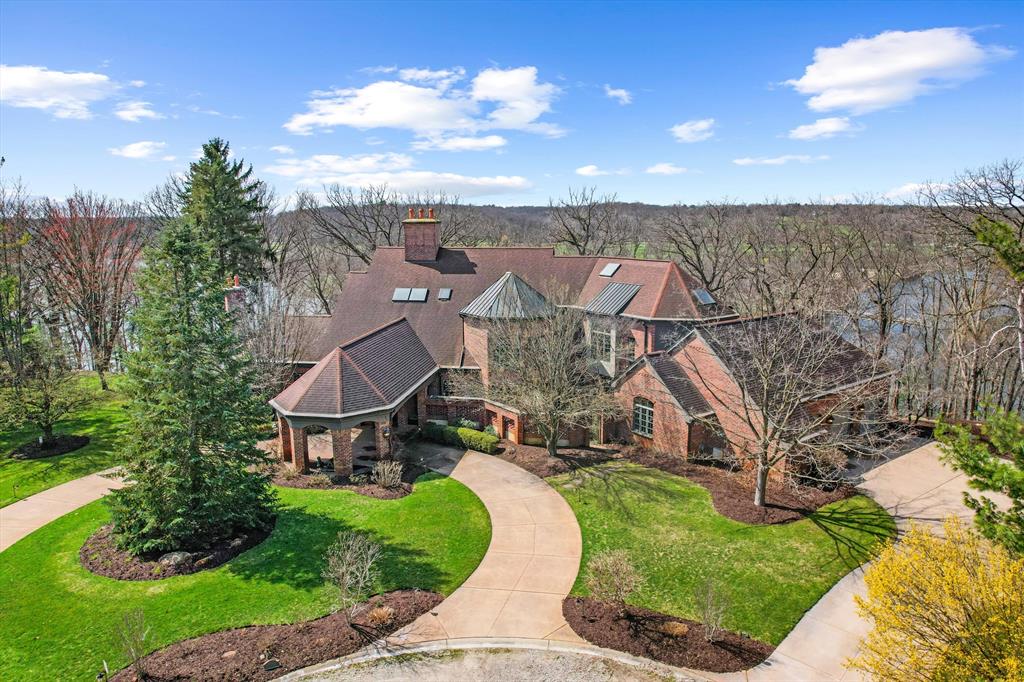 The view of the Huron River is unsurpassed from this hillside perch nestled in trees, from which you can watch swans glide past Gallup Park from every level of this architectural masterpiece that has never been on the market. Traditional spaces like a formal dining and living room flow easily from one to the next, but with unique and delightful elements tied in, such as an indoor garden with a full-grown tree, spiral staircase, and incredible paneled conservatory with wet bar tucked discreetly in. Built for entertaining with connectivity to outdoor spaces like the dining patio, terrace with outdoor wood fireplace, and patio off the sunroom. An elevator provides accessibility to all floors, including to the massive primary suite with sitting room and 180* river view; sip morning coffee with the sun sparkling on the water below. Lower level suite and kitchenette; library, den, theater and 2 of 5 indoor fireplaces. 1.86 acre in Ann Arbor Township less than 3mi from either hospital.
