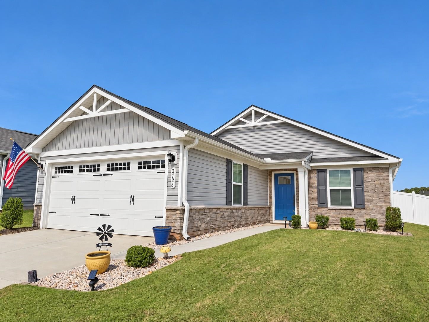 Enjoy easy, one-level living in this beautifully maintained home in Elmwood Cottages off Old Furnace Road, conveniently between Hwy 9 and Hwy 176. Ideally located in Boiling Springs and just minutes from Inman. Hop on I-26 or I-85 in no time to get where you need to go. Built in 2023, this cozy ranch offers 2 bedrooms, 2 full baths, and a versatile flex room—perfect for a home office, hobby space, dining room or even a future 3rd bedroom addition. With brand-new carpet in both bedrooms and the flex room, well-kept walls, and thoughtful upgrades throughout, the home feels fresh, inviting, and like new.  The kitchen features granite countertops, convenient pull-out shelves in the lower cabinets, and a pull-out trash cabinet to keep everyday essentials neatly tucked away. Luxury vinyl plank and ceramic tile flooring complement the new carpet, while the primary suite includes a walk-in closet and private bath with a tile shower. Both bathrooms also feature granite countertops. A smart thermostat, included window blinds, and an attached two-car garage add everyday comfort and convenience.  Outside, enjoy a patio and a neatly maintained yard with a premium white vinyl privacy fence and full-yard underground irrigation. Lawn maintenance is included in the HOA dues, covering mowing, edging/trimming, blowing, fertilization, and weed treatments—giving you more time to enjoy your home and less time spent on yard work. The community also offers a shared barbecue and outdoor sitting area with a beautiful view.  Combining a convenient location, exceptional care, and the simplicity of single-story living, this charming home is ready for its next chapter.