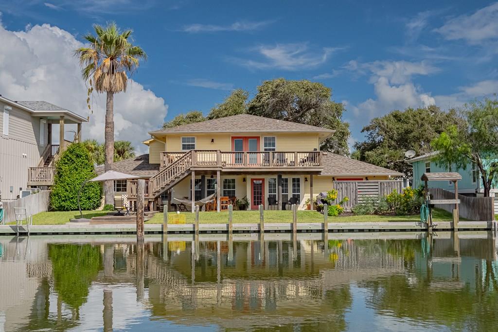 Imagine a place where every day feels like a vacation, a coastal haven nestled on Rockport's exclusive Key Allegro. Welcome to 4 Pelican, a remarkable two-story waterfront home that's more than just a residence – it's a lifestyle waiting to be embraced. From the moment you arrive, you'll feel the inviting charm. This isn't just one home; it's practically two, perfect for multi-generational living, effortlessly hosting friends and family, or an incredible investment opportunity. Perfect for generating rental income while you relish the excitement of waterfront living. The ingenious dual living spaces, each boasting its own kitchen, living room, and dining area, provide unmatched flexibility. With three spacious bedrooms and three baths, everyone enjoys their private retreat. Step outside and the magic unfolds. The shady-side orientation ensures comfortable outdoor enjoyment, while multiple decks offer breathtaking panoramic views of both vibrant sunrises and sunsets – your ultimate entertainment stage. Picture morning coffee in the tranquil Zen garden, complete with a soothing fountain, offering a peaceful start to your day. The newly installed mini-split in the foyer ensures year-round comfort, a thoughtful touch to this already exceptional property. Beyond the home, a new bulkhead offers easy canal access for your boating adventures. Key Allegro sweetens the deal with a community pool, scenic Bayfront walks, and quick access to Fulton Beach Road, leading you to the charm of Fulton and Rockport. Don't just dream of coastal living – live it!