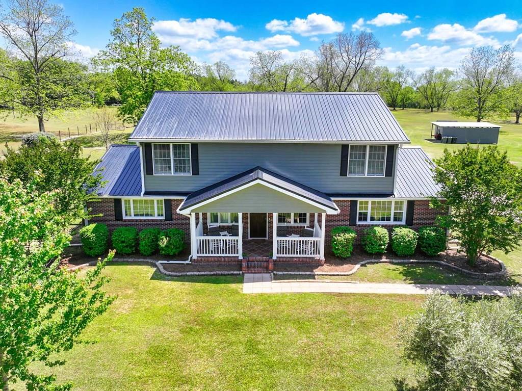 Spacious home on over 15 acres in the country!!! Welcome to 1594 Dollar Store Rd, a peaceful Thomas County retreat where privacy meets comfort and everyday convenience. This home has been well loved and well maintained and is just waiting for its next big family.  Ideally located just 20 minutes from downtown Thomasville and 15 minutes from Cairo, this property offers the perfect balance of quiet country living with easy access to town.  Situated on just over 15 acres, this stunning 6-bedroom, 3.5-bath home offers exceptional space both inside and out.  Designed with entertaining in mind, the home features a spacious living room, separate family room, formal dining room, and a screened-in porch, perfect for gathering with family and friends. The well-appointed kitchen is equipped to handle it all, complete with double ovens, a cooktop, and a large pantry.  The main level includes two bedrooms, highlighted by a generously sized primary suite with a walk-in closet and a luxurious ensuite bath featuring a garden tub and separate shower, your own private retreat.  Upstairs, four additional bedrooms provide incredible flexibility, easily accommodating a home office, gym, craft room, or guest space.  The oversized two-car garage includes built-in counters and cabinetry, making it ideal for a workshop or hobby space. Outside, enjoy the peaceful setting from the tree swing or cultivate your green thumb in the garden area. A pole barn and utility building provide ample additional storage. There's an area in the back that's fenced, perfect for your pooches to play.  Plus there's a fenced pasture area and plenty more room for horses or other livestock. Additionally there are producing pecan trees throughout the property. This property offers the rare combination of space, functionality, and serene country living with convenient access to nearby amenities. This is that home in the country  with space to grow that you've been looking for. The land is in two parcels; approx 5 acres with the house and an adjoining 10.3 acres. Perfect if you'd like to build a second home on the property. Roof is two years old and the crawl space is encapsulated.