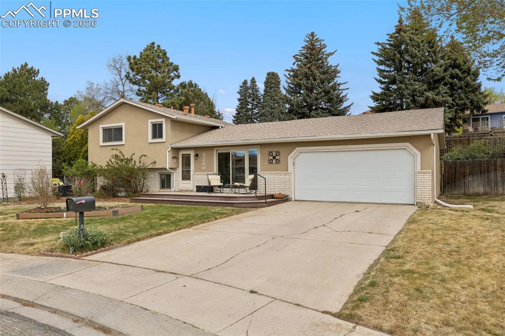Welcome home to this charming tri-level tucked away in a quiet cul-de-sac in desirable Vista Grande Terrace! Bursting with curb appeal in a truly serene setting. Step inside to a super functional floor plan designed for comfortable everyday living. The cozy lower-level family room features a wood-burning fireplace—perfect for those chilly Colorado evenings—while the walk-out access seamlessly connects you to the backyard oasis. Outdoor lovers will fall in love with this gardener’s dream! The fully landscaped and fenced backyard showcases a beautiful, terraced garden complete with drip and spray irrigation systems, a tranquil water feature, and a charming cedar garden shed. Whether you're planting, relaxing, or entertaining, there’s no shortage of inviting outdoor space, including a covered patio ideal for gatherings. Additional highlights include central A/C to keep you cool in the summer, a south-facing driveway to help with winter snow melt, and convenient travel trailer or camper van parking with an electric hook-up along the side yard. The garage also offers direct access to the backyard for added functionality. The lot is surrounded by mature trees for added privacy (without the maintenance on the property itself), this home blends comfort, charm, and opportunity in a wonderful location. Don’t miss your chance to make it your own!