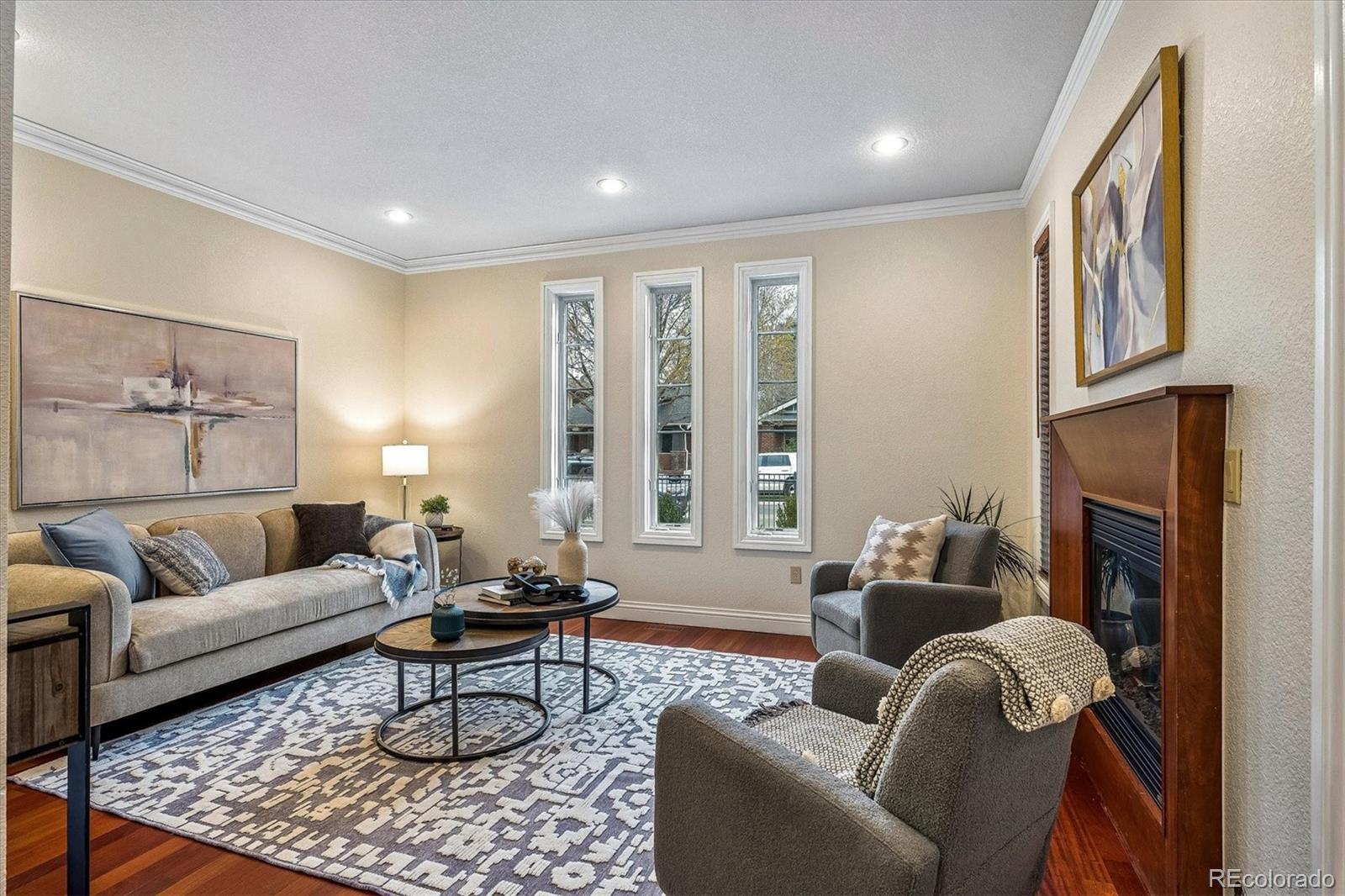 Perfectly positioned just half a block from iconic Washington Park, this exceptional townhome offers the ultimate blend of location, luxury, and lifestyle. Enjoy strolls to beloved neighborhood cafés and restaurants, with Cherry Creek North’s premier shopping, dining, and galleries just moments away. Recently refreshed and designed for effortless entertaining, the open-concept main level features a spacious kitchen with center island, slab granite countertops, and stainless steel appliances, flowing seamlessly into light-filled living and dining areas. The front living area with fireplace could also make a great office for the work at home professional.  Indoor-outdoor living is elevated with a privately fenced backyard—ideal for morning coffee, alfresco dinners, or relaxing evenings at home. The primary suite is a true retreat, complete with a cozy fireplace, spa-inspired en-suite bath, and a walk-in closet outfitted with custom built-ins. A second en-suite bedroom completes the second floor.  Upstairs, a versatile "rooftop" room opens to a private deck showcasing breathtaking park and mountain views—an inspiring space for the ultimate home office, studio, or lounge. Additional highlights include a finished basement offering flexible living space wired for surround sound plus a third bedroom and 4th bath. A two-car garage offers added convenience. This is refined urban living at its best—steps from the park, surrounded by vibrant amenities, and thoughtfully designed for modern Denver living, in move-in condition.