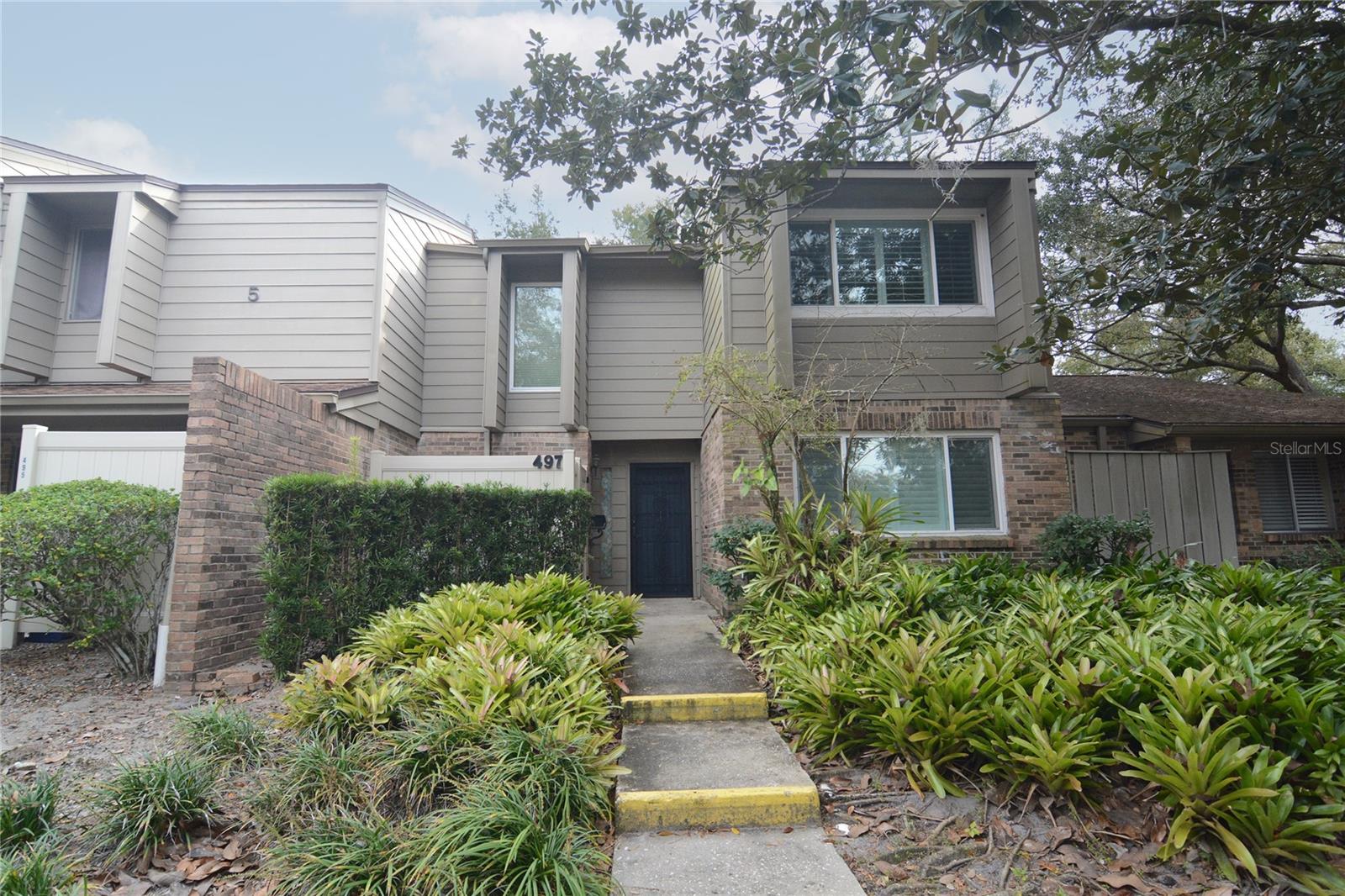 The condominium is in a super location of Altamonte Springs. Oak Harbour is a gated community with Lake access to beautiful Lake Orienta where boating and fishing are permitted. The lake is stocked with fish, and you can easily fish from the pier. The living room's back wall has a cathedral ceiling with large windows to let in awesome natural light. The windows and sliding doors are newer and are double paned with a 155- mile wind rating. The other windows in the home have white plantation shutters. The dining room is located off the kitchen for easy entertainment and downstairs there is a half bath plus the downstairs bedroom that would be great for an office for those that work from home. The home has substantial amounts of storage with a total of 9 closets. Upstairs the bedrooms are set up like two Master Suites, the larger bedroom has a walk-in closet with en-suite that has a walk-in shower. The other bedroom is spacious and has a view of the trees and green space, the bathroom has a tub shower. The AC unit is 11 years old and has been maintained with yearly check-ups. There are two assigned parking spots right out front of the door. The community has many trees and mature landscaping along with a furnished clubhouse with a fitness center, library, kitchen, and fireplace. Outdoor facilities include swimming pools, shuffleboard, tennis courts, playground, BBQ area, and private boat ramp into Lake Orienta. The location is near to the hospital, shopping, restaurants, and Sun Rail. Easy access to 436 and I4.