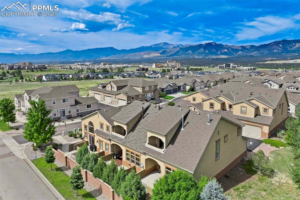 A private gated courtyard framed by evergreens & mature trees invites you in to, this end-unit townhome offers rare year-round privacy in the heart of Northgate. Located walking distance to Loyal Coffee, boutique shops, & all the new entertainment options on the north side of town. Including the Ford Amphitheater, IMAX movie theater, Top Golf,  & tons of dining options. This home also provides easy access to D-20 schools, the United States Air Force Academy, & I-25 for quick commuting.
Inside, solid oak hardwood floors flow throughout the entire main level, beginning in the vaulted great room anchored by a gas fireplace w/ tile surround & a full wall of windows that flood the space w/ natural light. The open layout leads into a generously sized dining area w/ sliding glass doors that open to the private front patio courtyard—perfect for outdoor dining or morning coffee. The kitchen blends function & style w/ breakfast bar seating, solid wood cabinetry w/ brushed metal pulls, tile backsplash, pendant lighting, pantry, & nearby half bath featuring hardwood flooring & a tile countertop.
The main level also includes a spacious laundry/mudroom offering ample cabinet storage, countertop space for folding, a sink, & access to the oversized two-car attached garage.
Upstairs, all-new carpet sets the tone for a refreshed upper level. The vaulted primary suite includes a ceiling fan, gas fireplace, & private covered balcony w/ Trex decking & views of the natural landscape. The adjoining 5pc bath has an oversized soaking tub, dual vanities, & new LVP flooring. Two additional upper-level bedrooms enjoy mountain views—one is oversized—& both share easy access to hallway bath complete w/ a double vanity & tiled tub/shower surround.
Additional highlights include central A/C, energy-efficient windows, high-speed internet, & low-maintenance living w/ HOA-managed exterior care. This home is a must-see.