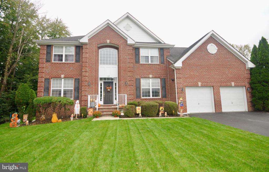 Location, location, location! Welcome to this stunning brick-front Colonial nestled in the highly desirable Saddlebrook Estates—truly a hidden gem offering exceptional privacy on a quiet cul-de-sac. Set on nearly ¾ of an acre, this home is surrounded by township-owned land, mature trees, and designated wetlands, ensuring lasting peace and no future construction behind or beside the property.The beautifully landscaped backyard is your private oasis, featuring an in-ground pool and spa with heater and decorative waterfall, perfect for relaxing or entertaining. A private vinyl open fence, paver walkway, and inviting patio create a seamless transition to the outdoor living space.Inside, this expanded Upton Center Hall Colonial offers approximately 3,098 square feet of finished living space with 9-foot ceilings and gleaming hardwood floors throughout the main level. The grand foyer impresses with its chandelier lift system for easy maintenance and sets the tone for the quality found throughout the home.The open-concept kitchen and family room are ideal for today’s lifestyle, boasting granite countertops, tiled backsplash, center island, pantry, abundant cabinetry, and full appliance package along with all pool equipment. The adjoining family room features a cozy fireplace and flows beautifully into the sunroom. A private office with French doors sits just off the foyer, while the formal living and dining rooms connect seamlessly—perfect for entertaining.A versatile bonus room with ceramic tile flooring offers its own heating and central air and is accessed through the family room, making it an excellent playroom, home office, or entertainment space.Upstairs, the expansive primary suite (20’ x 25’) includes a sitting area, walk-in closets, and a spa-like en-suite bath with Jacuzzi tub, shower, and oversized vanity—your personal retreat at the end of the day. Three additional bedrooms offer generous closet space and share a well-appointed hall bath.The full basement features poured concrete walls, with endless potential for additional living space. More pics coming soon. (Exterior pics are previous before current snow storm  FYI)