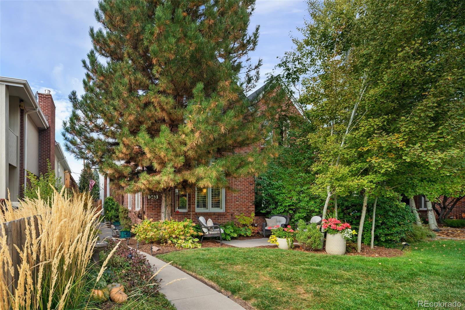 Sophisticated sanctuary in the heart of Cherry Creek North full of exceptional upgrades making this home one of a kind. 
Welcome to a gorgeous, meticulously maintained townhome offering refined living and a private outdoor oasis—nestled among mature trees and lush landscaping.
Step inside to a spacious, light-filled interior where rich hardwood floors flow seamlessly throughout the main level. The living room exudes warmth and elegance with soaring ceilings, crown molding, a cozy gas fireplace, plantation shutters and abundant natural light. A built-in sound system adds ambiance throughout the home.
The gourmet kitchen is a chef’s dream, featuring a large Quartzite Island with counter seating, premium Thermador appliances, bay window. and dazzling new Schonbek crystal chandeliers. Adjacent to the kitchen, a versatile bonus space awaits—perfect for a formal dining room, home office or space to unwind, already plumbed for a wet bar.
Step outside to your secluded patio retreat, ideal for entertaining or unwinding. Enjoy the firepit, tranquil water feature, outdoor TV, and a beautifully lit pergola surrounded by manicured landscaping. A newly installed 7.5 -foot privacy fence completes this serene escape.
Upstairs, the expansive primary suite offers a peaceful haven with high cathedral ceilings, a charming window seat, ceiling fan, and generous closet space. The luxurious ensuite bath features heated tile floors, a soaking tub, dual vanities, and a spacious walk-in shower and skylight —your personal spa after a long day.
A stunning secondary bedroom completes the upper level, boasting vaulted beamed ceilings, natural lighting and a sleek ensuite bath your guests will never want to leave.
The finished lower level includes high ceilings, light-filled secondary guest bedroom, large family room (or non-conforming fourth bedroom), a remodeled full bath, and laundry room with new washer and dryer. Ample closets and storage as well for all of your extras.