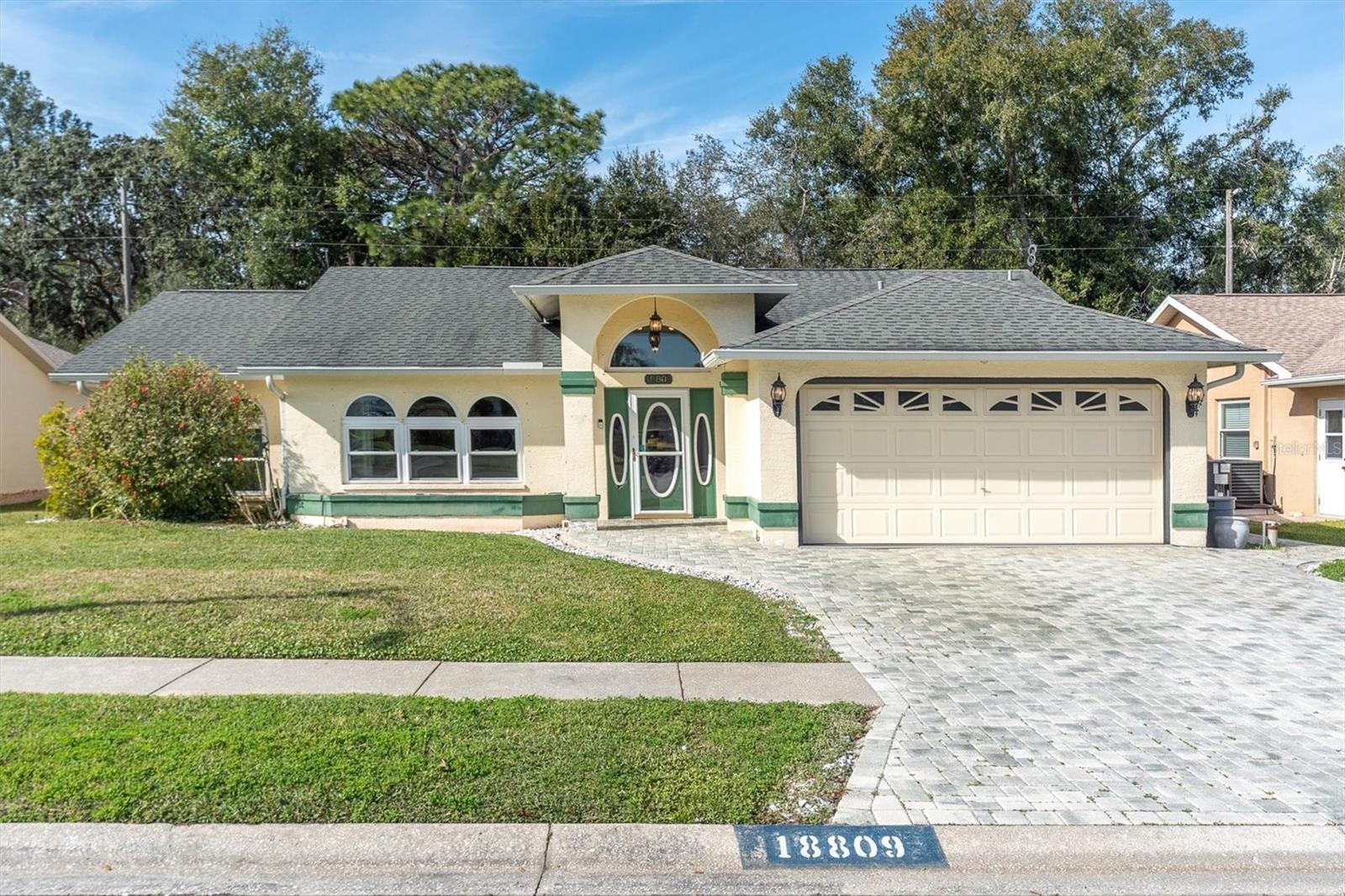 Enjoy not having rear neighbors with this PRIME conservation lot! This beautiful heated screened-in pool home has a split floor plan, vaulted ceilings, and plenty of room for the entire family. Welcoming brick-paved oversized driveway. Custom etched glass double door entry. 2017 all new windows and doors. The roomy kitchen has stainless steel appliances, granite countertops, a breakfast bar, a large cabinet pantry, and an eat-in area. Inside laundry. The oversized primary bedroom has a walk-in closet and overlooks the pool area. The en-suite has a double sink vanity. Enjoy peace of mind with all public utilities, no flood insurance required, no CDD fees, and water your yard for free with the sprinkler system on a well. This home has stayed high and dry through all hurricanes. Heat your pool with solar panels from 2020. The pool area is meant for entertaining, painted with a tropical mural, screened-in, and with plenty of space to grill and relax poolside. HOA only $167/year. Conveniently located to all you need: shopping, dining, and all the necessities of life!