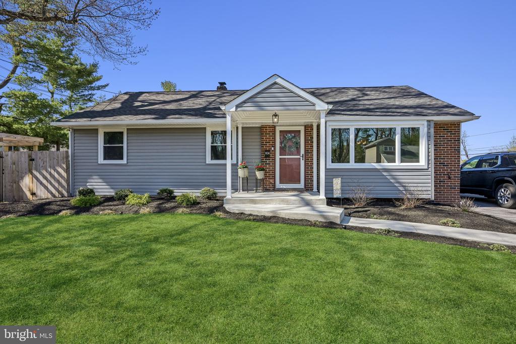 Expanded ranch located on a quiet dead end street, completely renovated inside and out with a contemporary, designer flair. From the moment you arrive, you'll notice the impressive exterior upgrades including new siding, driveway, sidewalks, front porch, and professional landscaping.Step inside to an inviting living room featuring gleaming hardwood floors and new recessed lighting. The designer eat-in kitchen is both stylish and functional, offering stainless steel appliances, a gas stove, built-in microwave, glass tile backsplash, wood countertops, a large deep stainless sink and ceramic tile flooring. The dining table with extra leaf and chairs are included. Charming built-in shelving and bench seating add both character and practicality.The spacious primary bedroom offers a walk-in closet, decorative clapboard accents, barn door, ceiling fan, and recessed lighting. The beautifully updated primary bath features a sleek shower and ceramic tile flooring. A second bedroom with clapboard detailing and an updated full hall bath complete the main level. Abundant storage throughout.Enjoy additional living space in the cozy enclosed back porch to use year round, perfect for relaxing or entertaining. The full basement provides even more space for recreation with built-in shelving, storage, or future finishing. A pull-down attic offers convenient additional storage.The backyard is a true retreat, featuring a stunning patio with built-in grill, refrigerator, and sink, plus an outdoor shower, a raised garden bed with irrigation, an inground pool, and two storage sheds. Please note: the pool is being sold in "as-is" condition, though it was painted and resurfaced in 2025 with no known issues.Major systems upgrades include newer windows, hot water heater, furnace, electrical panel, plus the added peace of mind of a one year home warranty.