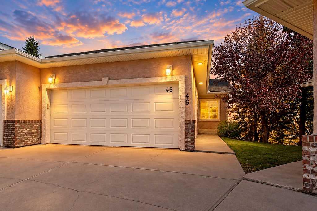Welcome to this beautiful bungalow villa in a well kept and quiet complex in Harvest Hills. The spacious main floor has a vaulted ceiling, 2 bedrooms, 2 full bathrooms and main floor laundry. Enjoy updated kitchen and bathrooms upstairs, including elegant white cabinets, stone countertops and stainless steel appliances. The wood grain laminate floors through the living room and kitchen are easy to clean and look great! The kitchen has all the storage you need with many cabinets, pantry and large functional counterspace for cooking or entertaining. From your dining area, enjoy morning coffee or evening drinks on your private deck overlooking a walkway and pond instead of other homes. The primary bedroom is spacious and offers a walk-in closet and private ensuite. The main floor also has a second bedroom, or the perfect space for home office. A large fully finished basement provides unique charm with a massive sunken family room with gas fireplace and walking out onto a patio in your backyard with peaceful views of trees and the pond. Elevated above the family room is another large flex room, as well as a third bedroom and 4 piece bath.  The basement also has a mechanical room with plenty of storage space, and the plumbing has been updated (no more polyB pipe). Stay cool in the summer with air conditioning, and keep your cars and toys warm in the winter thanks to the double attached garage. This lovely cul-de-sac of villas is for adults over 18, and even though it is not a condo, your lawn maintenance, snow removal, roof and fence maintenance are taken care of through the homeowner associations low fee!
