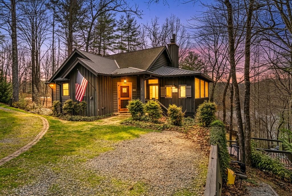 A rare opportunity for qualified buyers (doesn't have to be a veteran) to assume a 2.25% VA loan for $325,000 of the purchase price, which gives you the mortgage payment of a $450,000 property.  This freshly painted, fully furnished mountain retreat in the sought-after Cross Creek community blends refined craftsmanship with everyday ease.  Antique oak floors, custom millwork, and a native stone fireplace create timeless warmth, while the chef's kitchen shines with KitchenAid appliances, a professional gas range, walk-in pantry, and a breakfast-bar island.  The primary suite is a true escape, featuring a spa-inspired bath, double vanities, and a spacious walk-in closet.  Built-in shelving in the bedrooms and living room add character and smart storage.  Enjoy two screened porches-one with a fireplace and gym setup-and a firepit patio with seasonal views of the mountains and Lake Santeetlah.  Fiber optic and Starlink keep you connected, and the finished basement, attic storage, and included second lot offer endless flexibility for future expansion.  Cross Creek's clubhouse, pool, tennis and pickleball courts, plus boat storage round out the resort lifestyle.