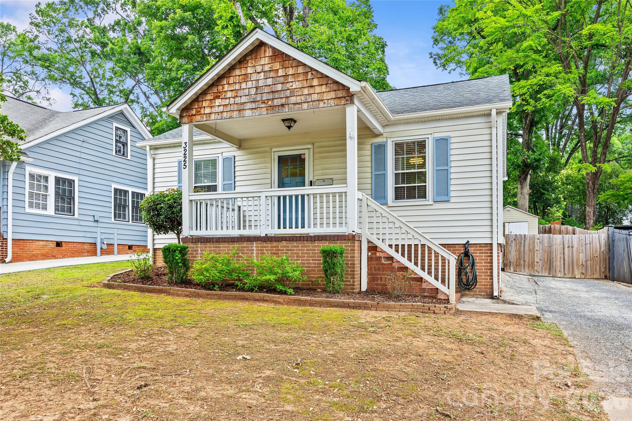 Welcome to 3225 Commonwealth Ave — a charming bungalow nestled in the heart of sought-after Commonwealth Park. Inviting covered front porch. Step inside to warm hardwood floors flowing throughout the home. The large, bright living room offers plenty of space to gather or lounge!The updated kitchen shines with freshly painted cabinets, new tile backsplash, modern lighting, crown molding, and durable tile flooring. This space opens seamlessly into a dining area featuring custom bench seating, perfect for gatherings and everyday comfort. A dedicated laundry area offers additional storage and newly installed doors for a clean, finished look.The home includes a comfortable primary bedroom, a second bedroom, and a beautifully updated hall bath complete with a newly tiled shower with new glass door, updated vanity, and stylish tile flooring.Step outside to a fully fenced backyard — an ideal space for entertaining, gardening, or relaxing. Enjoy the deck for outdoor dining and take advantage of two storage sheds for all your tools and hobbies.Just minutes from everything Plaza Midwood has to offer!