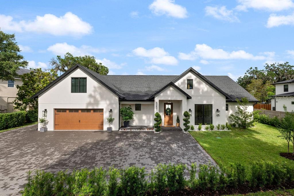 If you've been searching for an almost new, beautifully appointed four-bedroom, three bath custom home on a quiet low traffic street near downtown Orlando, then look no further.  Completed in 2023, this stunning Craftsman design features all four bedrooms, 3.5 baths, walk-in pantry and walk through laundry room on the first floor.  With 2,860 square feet of living area, high ceilings, great room, kitchen and dinette, the floor plan provides the openness for which so many are looking.  In this beautiful home the bedrooms are situated so the master bedroom/bath and huge walk in closet are one one side and the three guest bedrooms and two baths are on the other.  You will also be able to access the walk through laundry room from the master bath.  If you need or want an office, one bedroom has been outfitted with a custom built-in desk and custom built in book shelves.

This home is beautifully appointed.  Tile flooring that looks like authentic hard wood covers the entire ground floor.  Other quality features include double pane windows, soft close solid wood cabinets and drawers, quartzite kitchen counters, quartz counters in master bath and marble counters in the secondary baths.  The light fixtures are top of the line, think Restoration Hardware.  If you like to cook, the kitchen is a dream with ample counter space, large cooktop, oversized sink, built in oven as well as a built in convection oven and microwave.  A wine cooler is situated in the dinette area. Adjacent to the kitchen is a walk in pantry complete with a prep sink, counters and additional refrigerator.  Additionally, the home is equipped with security cameras and built-in speakers.  Tankless hot water heaters, water filtration and softening system guarantees warm, soft, pure water on demand. A decorative electric fireplace and built-in shelves lends atmosphere to the great room.  Upstairs there's a spacious media room with built-in speakers.  This location gives those who want to use it plenty of privacy as well as those who do not. Out the rear sliding door you'll find a covered lanai featuring beautiful dark grey tile floors overlooking a spacious back yard.  The driveway, complete with guest parking, features dark grey brick pavers.  Beautiful fresh landscaping is the ribbon on the package.

This home sits two streets away from Little Lake Conway.  The area consists of well cared for and updated homes built in the 50s, 60s, and 70s as well as new custom home like this one built in the 2020s.  It's a first class area that has character and charm, it's very convenient to downtown Orlando and feels like a place you would be proud to call home.