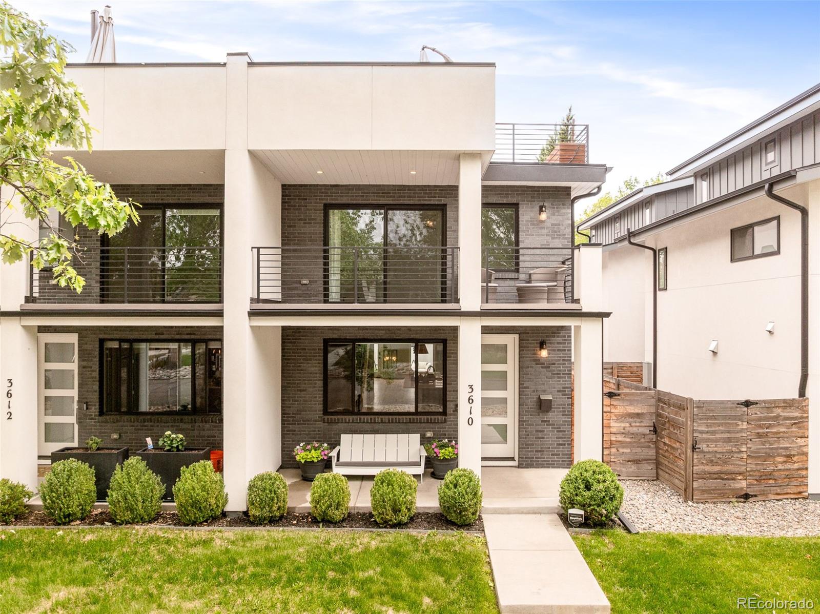 Effortless living on one of LoHi's quietest streets. Tucked on a quiet block in Denver's Lower Highlands, this four-bedroom, five-bath designer paired home places the best of the city close by. Michelin-starred Alma Fonda Fina is just blocks away, alongside Williams & Graham, The Family Jones, Wooden Spoon bakery, and the landmark Little Man Ice Cream. The restaurants of Tejon are a block away, and the pedestrian bridge to Union Station is six.Behind a white stucco facade with custom black Endicott brick and a covered front porch, the home has been freshly painted with newly refinished white oak floors. Black-clad Andersen windows, including an eight-foot main-floor slider, open to an east-facing patio with a gas grill line, and Hunter Douglas window treatments run throughout, motorized on the main floor, with Cat 5 wiring on every floor. A gas fireplace anchors the living area, and the kitchen is built for cooks: a fourteen-foot double-slab island, a dual-fuel six-burner range, a professional-grade hood, custom Crystal inset cabinetry, and a pantry with roll-out shelves.The primary suite opens to a west-facing covered balcony with custom closet buildouts, including a generous walk-in, plus built-ins at the entry. Its spa-caliber bath offers heated floors, Brizo wall-mounted faucets over a double vanity, a freestanding soaking tub, and a seamless glass corner shower. Two bedrooms connect through a Jack and Jill bath, and a fourth adds flexibility for guests or a home office.The newly renovated backyard adds raised garden beds, a fire pit, and an extended patio sized for an outdoor kitchen. A loft opens to an extended, turf-finished rooftop deck engineered to hold a hot tub. A home theater anchors the lower level, and a two-car detached garage completes the home.Set in one of Denver's most sought-after neighborhoods, this is a rare chance to own a home where design and location are equally uncompromising.