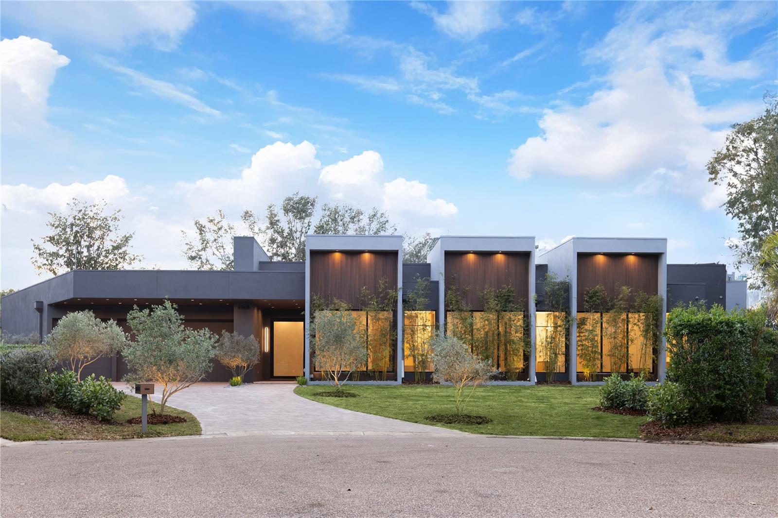 Under contract-accepting backup offers. Unparalleled Luxury & International Design in Prestigious Bay Hill, Dr Phillips This newly developed, architecturally unique residence in Bay Hill is not merely a house—it is an iconic masterpiece and an internationally inspired designer art piece that redefines the zenith of luxury living in Orlando.Your grand experience begins by passing through 10-foot modern pivot doors that open like magnificent stage curtains, revealing the home's spectacular scale: Italian hardwood planks grounded below soaring 20-foot ceilings. Sunlight floods the space, bathing a stunning indoor garden oasis with live mini olive trees—a breathtaking, bespoke element that sets an extraordinary tone for the entire estate.The gourmet kitchen is a true chef’s fantasy, taking center stage with a full suite of Dacor high-end stainless-steel appliances, a sleek oversize waterfall island of impeccable design, and a discreet, built-in Zephyr wine refrigerator. Every curated detail whispers uncompromising sophistication.Indulge in spa-quality opulence within the bathrooms, featuring exclusive Hansgrohe Axor fixtures and award-winning Duravit toilets. The master sanctuary is a haven of tranquility, complete with a double glass shower and a custom, hand-finished Dado soaking bath designed for ultimate rejuvenation.Seamless, sophisticated living is achieved through massive sliding doors that effortlessly draw the interior and exterior together. Step out to a breathtaking backyard retreat boasting a dramatic 65-foot shimmering pool, a chic pool deck paved in luxurious Amazon green limestone tiles, and a professional-grade Summerset summer kitchen—perfectly appointed for grand-scale entertaining.Sited within the ultra-exclusive Bay Hill community, known globally for its championship golf course and the yearly PGA Tournament, this estate places you moments from the world-class dining of Restaurant Row, luxury shopping, and Orlando’s renowned theme parks.This is more than a property; it is an enduring work of art. An iconic masterpiece awaits. Contact us now to arrange your confidential private showing and experience its allure firsthand.