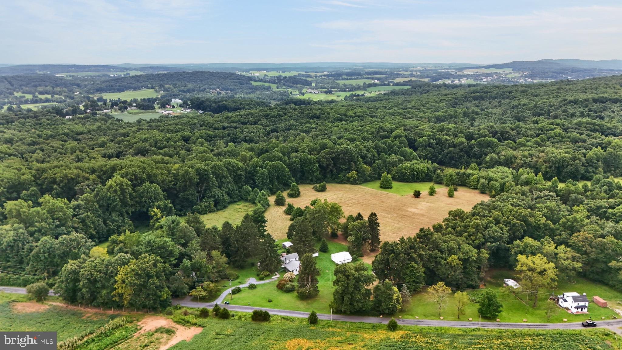 **This property will be offered at Public Auction on November 6, 2026 @ 4:00 PM. The listing price is the suggested opening bid only and in no way reflects the final sales price. $45,000 initial investment is due on auction date. 2% transfer tax to be paid by the purchaser. Settlement on or before December 31, 2026. Discover the beauty of Elverson on this private 14-acre farmette at 230 Laurel Road, set along a quiet dead-end lane and bordering State Game Lands. The three-bedroom, one-bath home was refreshed in 2024 with new insulation and drywall, an updated mudroom, a relaxing living room, and a roofed front porch, plus a basement with fireplace, concrete floor, and outdoor access. Outside, mature landscaping frames ample yard space, tillable ground, woods, and wildlife, with two tree stands already in place. Seven-plus outbuildings support a true homestead lifestyle, including a fully wired horse barn with a large stall, hay storage, second-floor space, and water hydrant, along with a run-in shed and horse stall, small animal pen, chicken house, garden shed, pigeon shed with lean-to, tractor shed, and wash house. A rare blend of privacy, recreation, and workable acreage in Warwick Township.